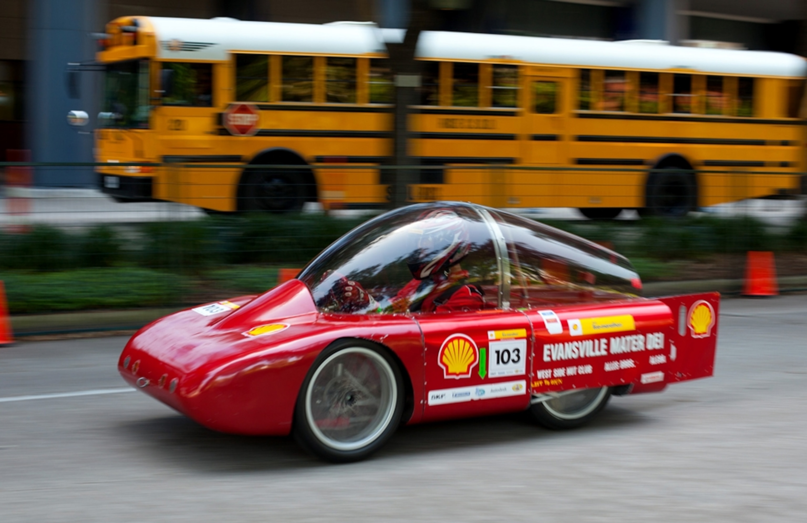 Sleek red vehicle with large clear plastic cockpit