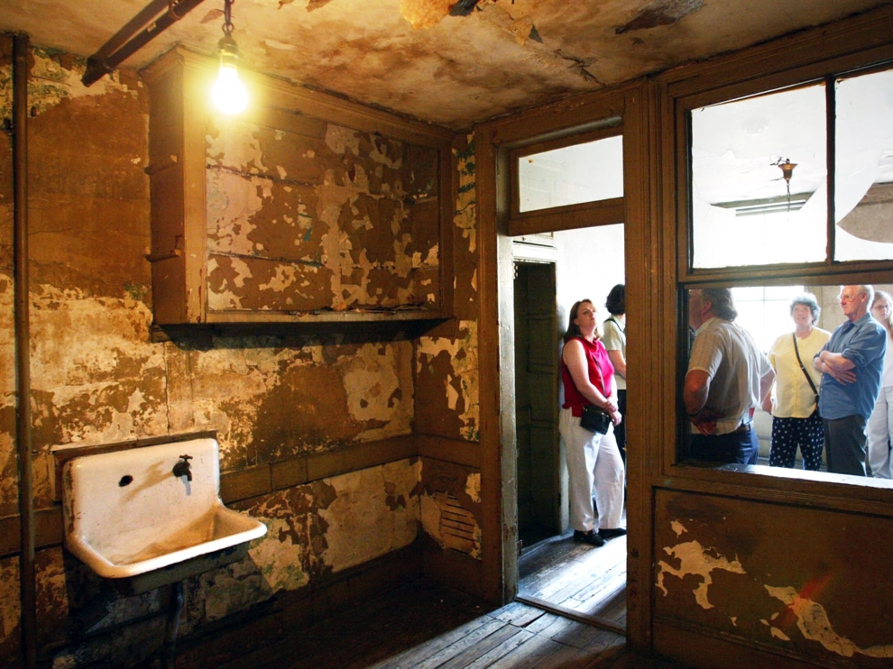 visitors touring a tenement apartment