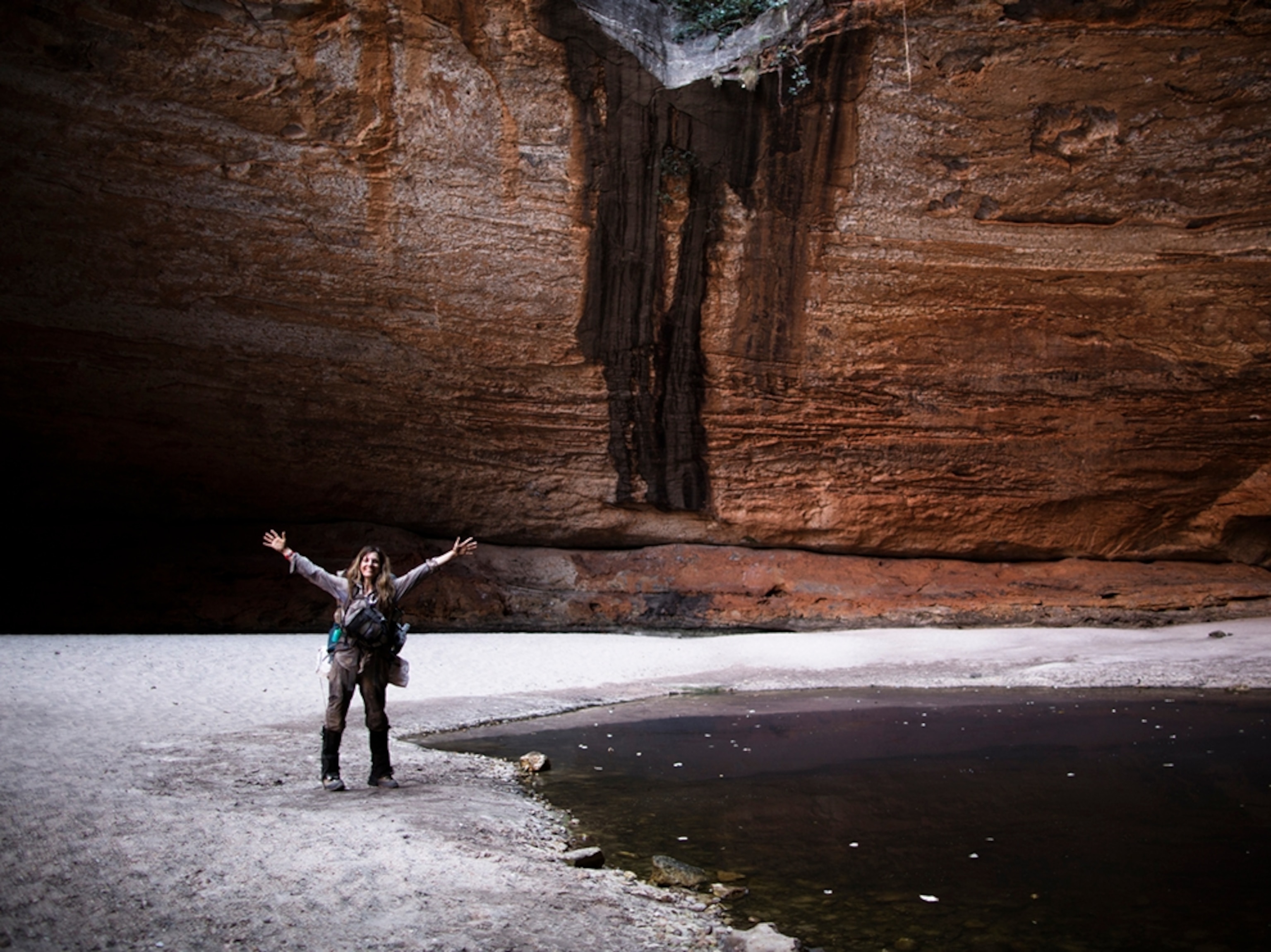 Sarah Marquis with arms raised up in celebration.