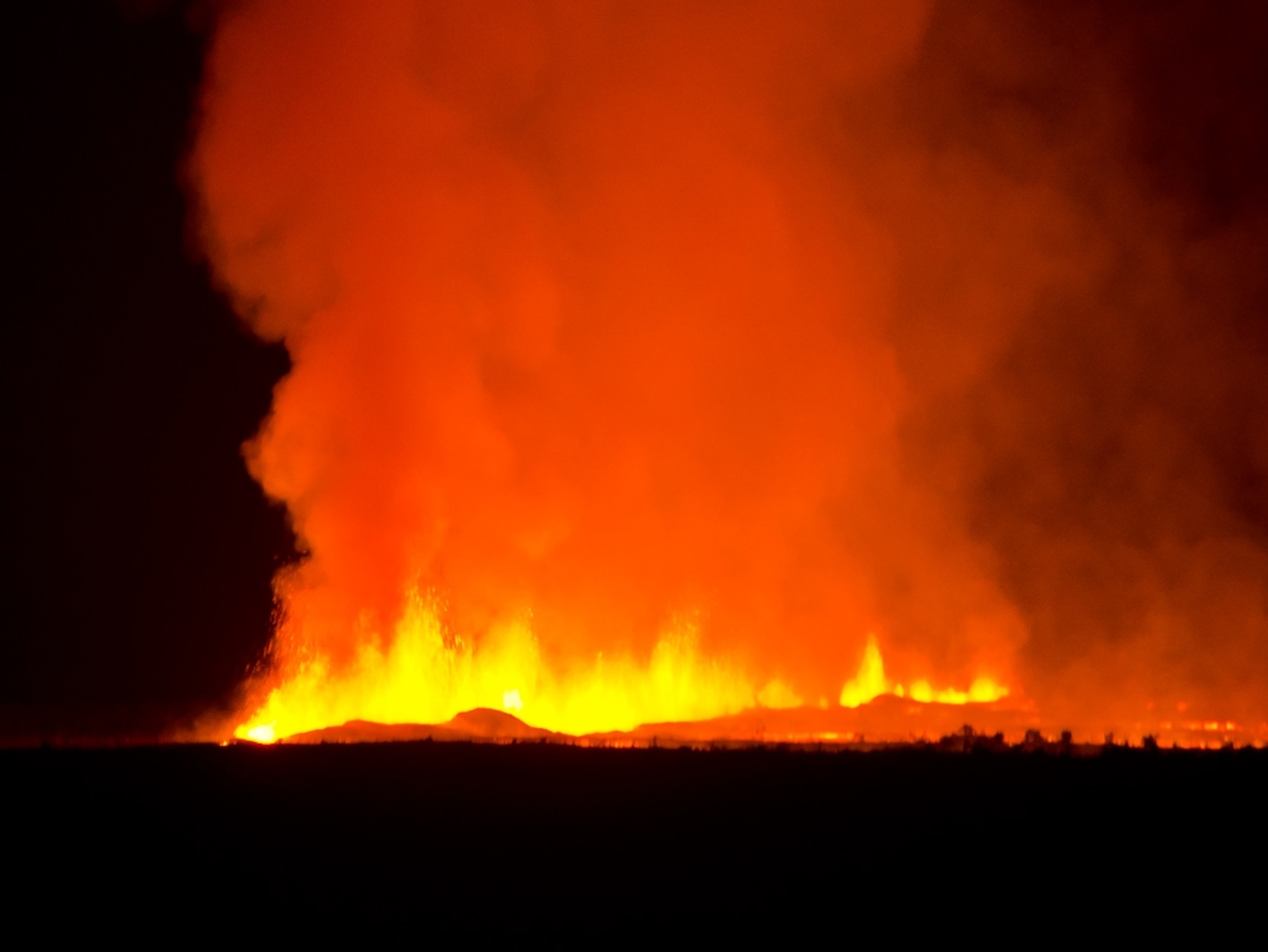 Volcano picture: orange lava erupting from the Nyamulagira volcano in Congo, Africa