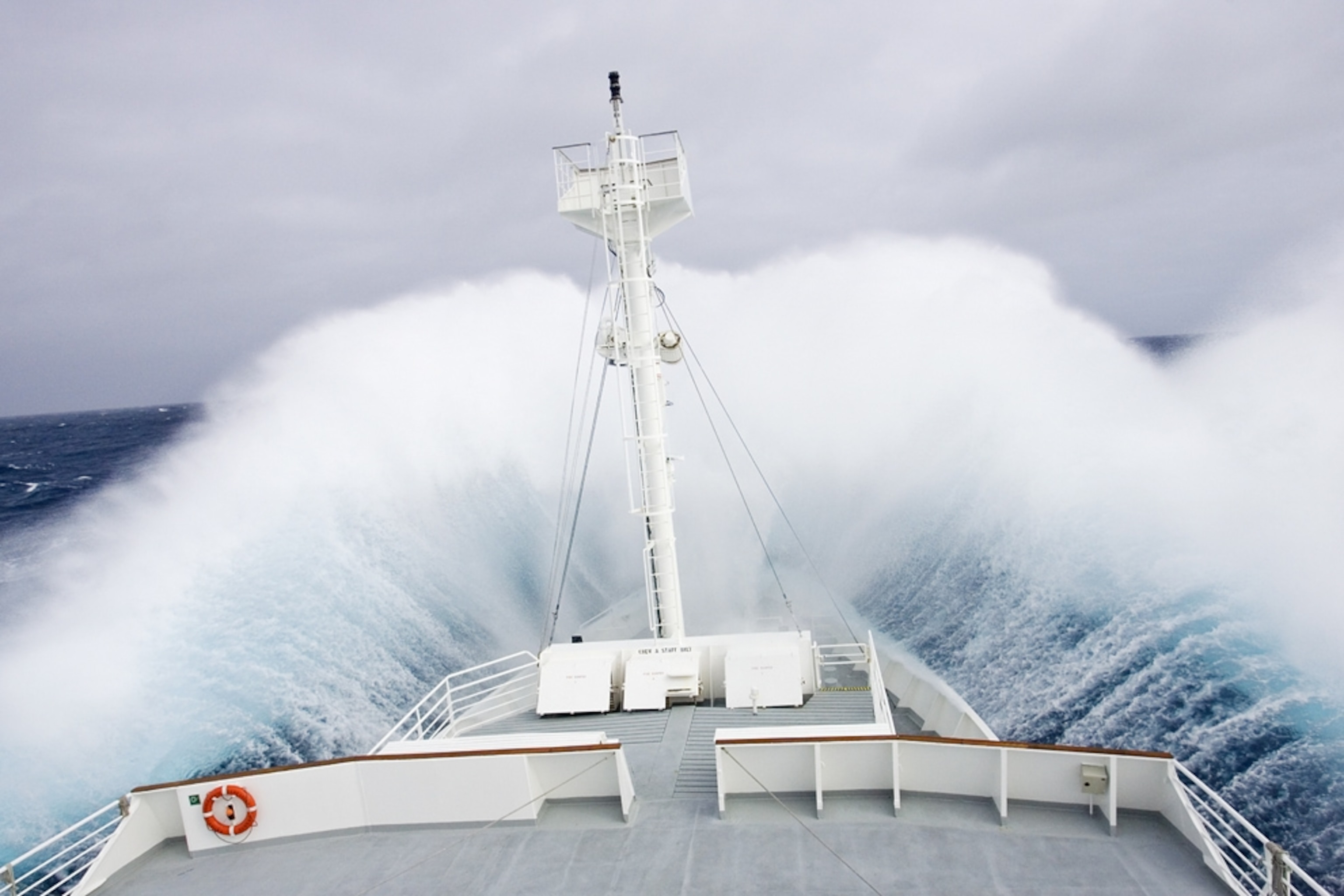 a ship cutting through waves in the Drake Passage near Antarctica