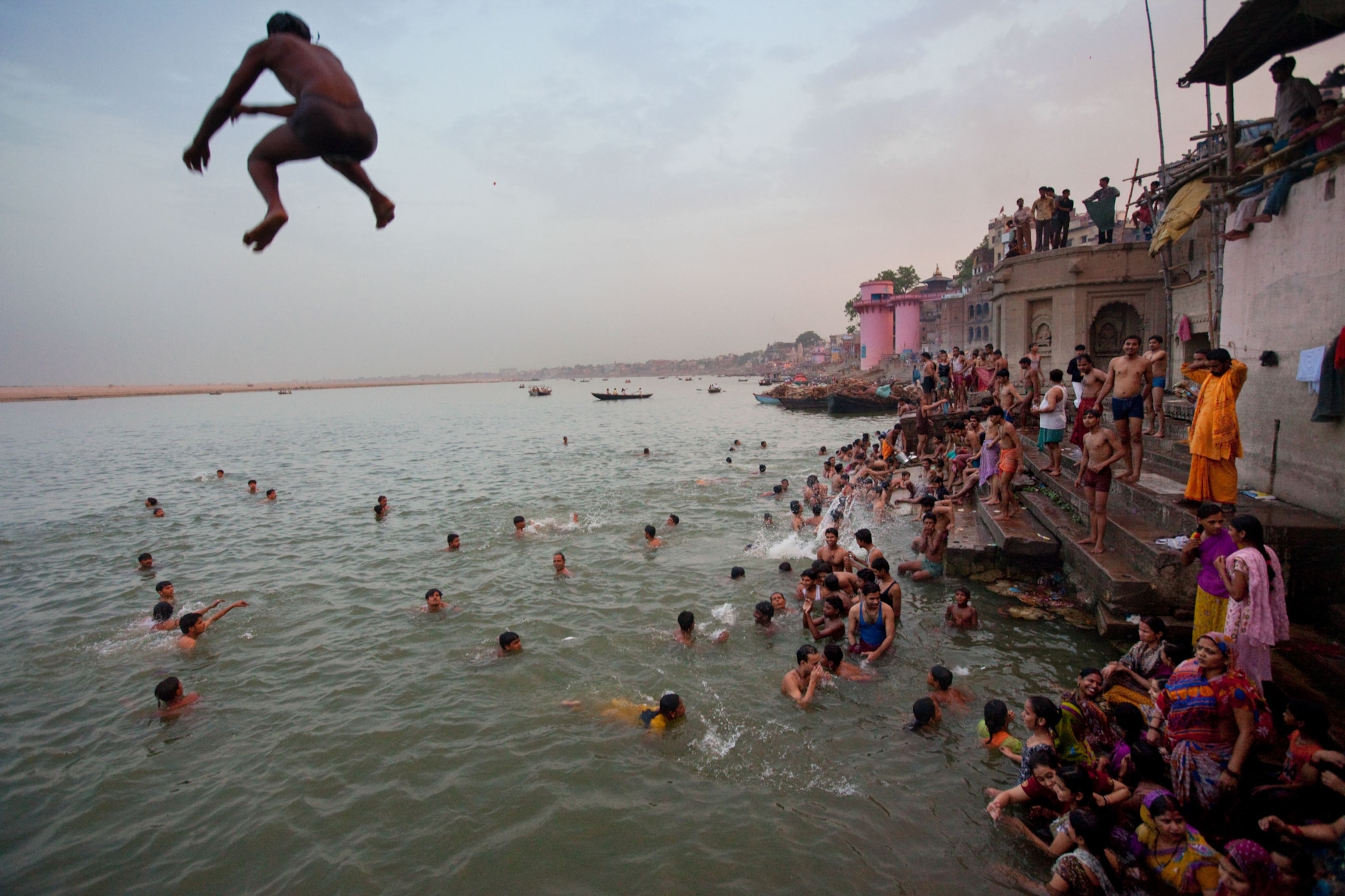 a boy jumping into the Ganghes River
