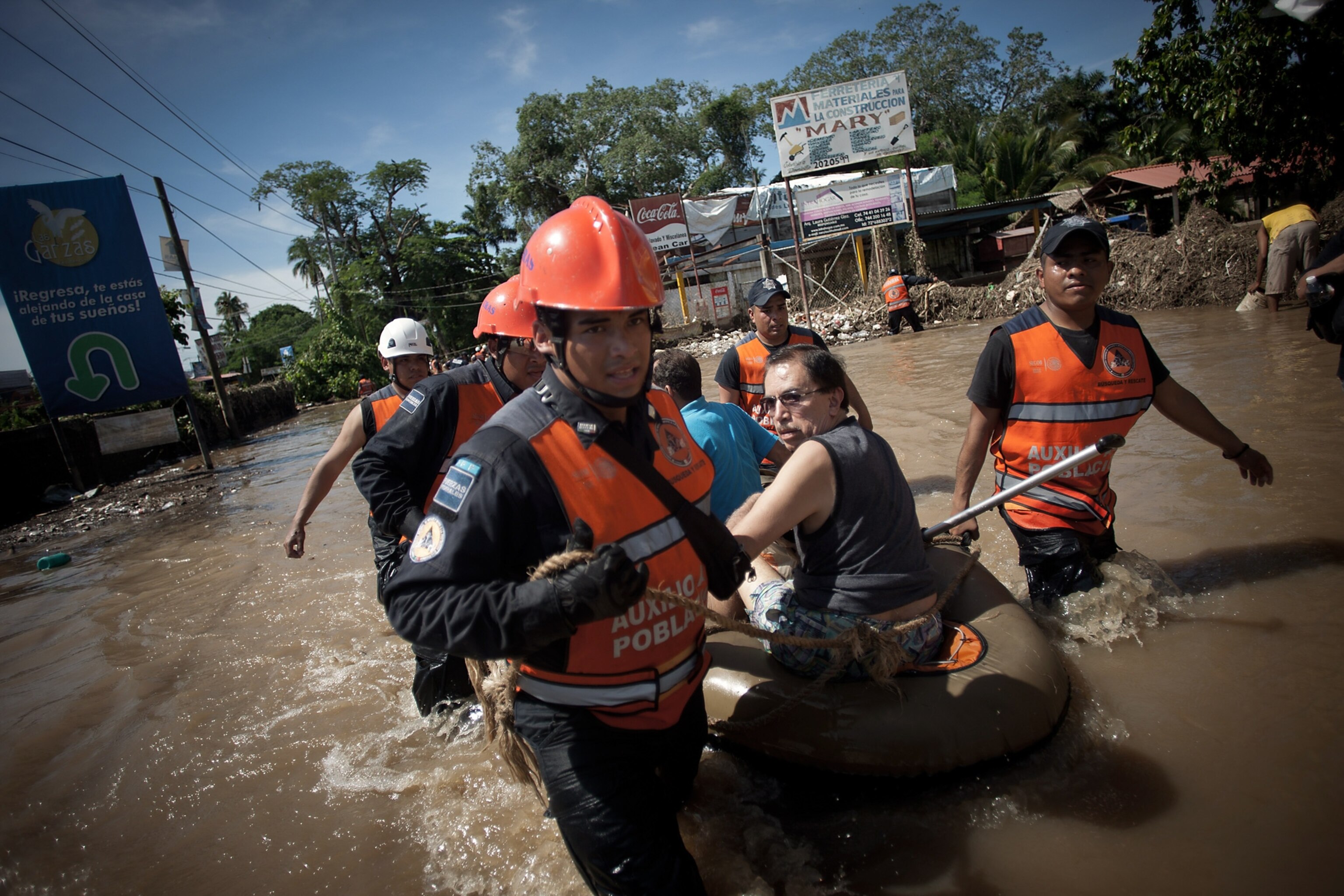 policemen helping victims of tropical storm Manuel in Acapulco, Mexico