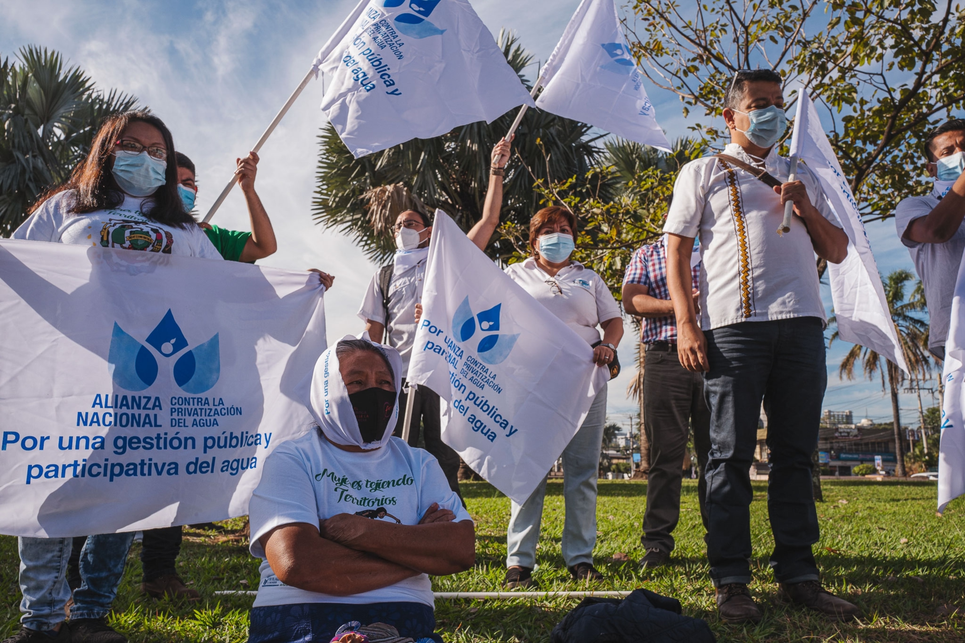 a group of people participate in a protest to get access to clean water