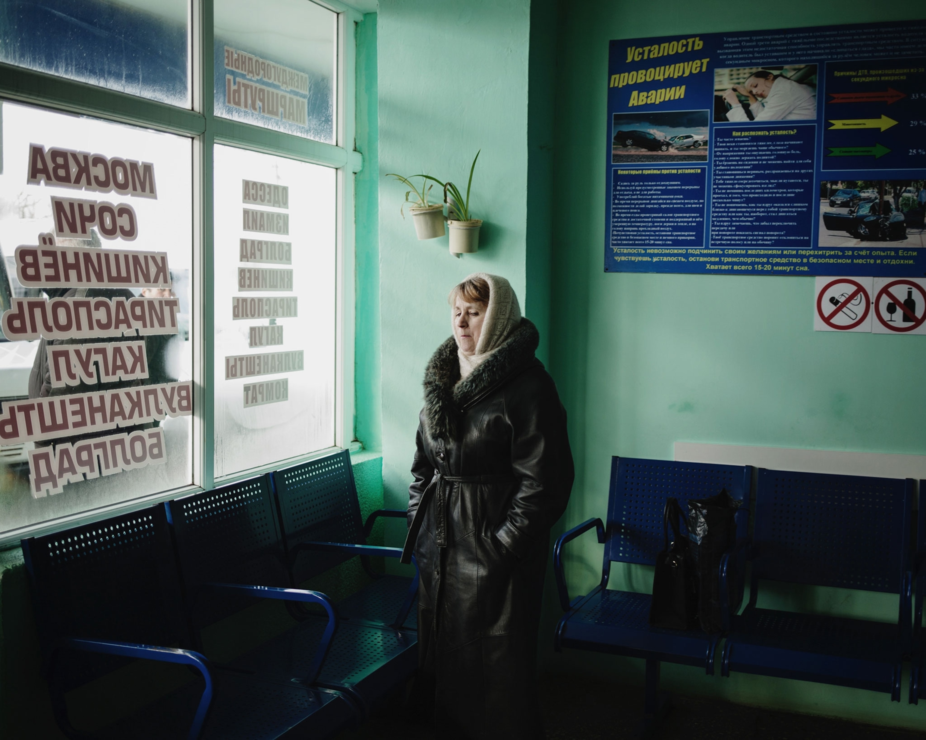a woman waiting in a bus station