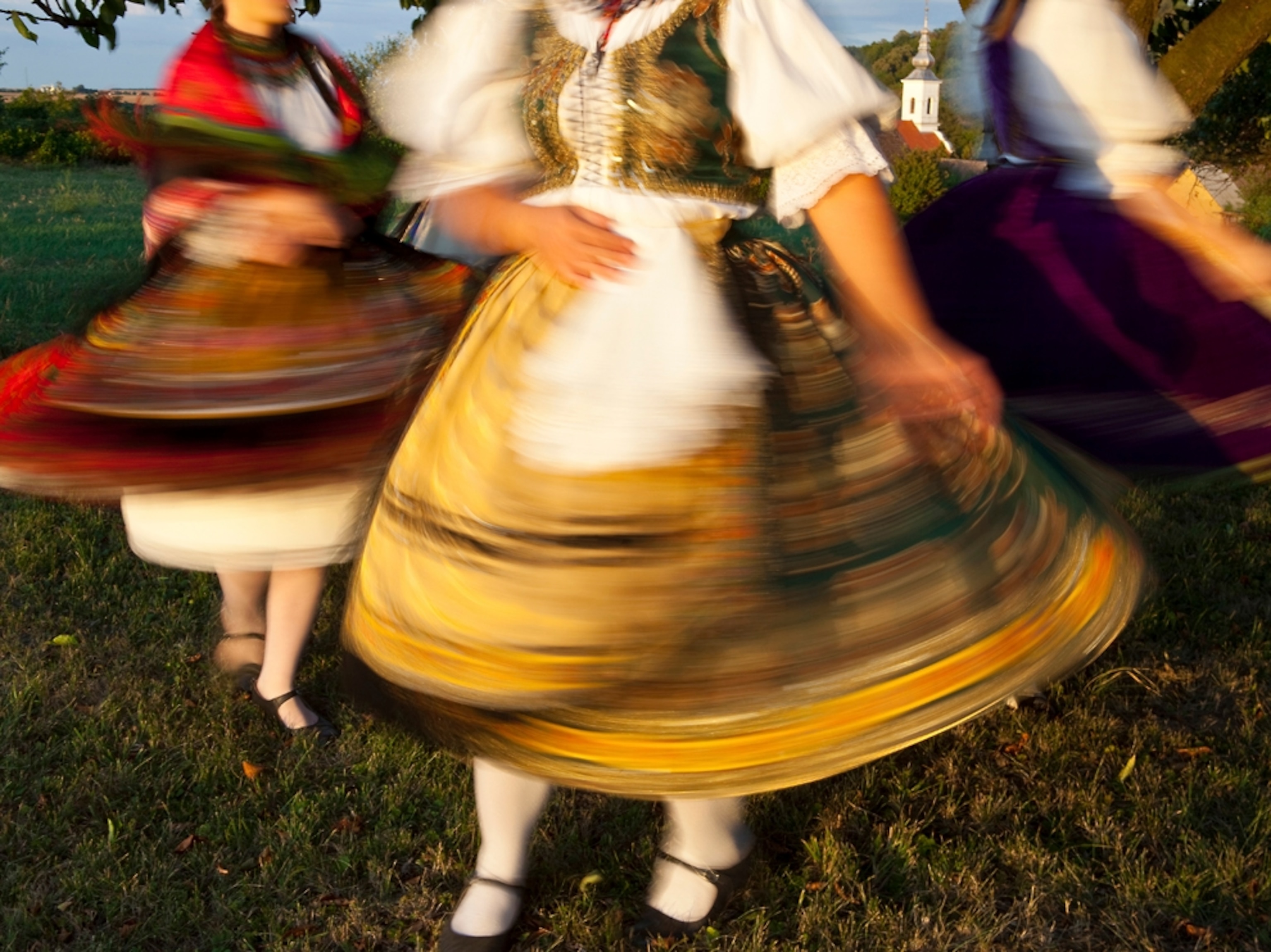 Women in Hungarian dresses twirl