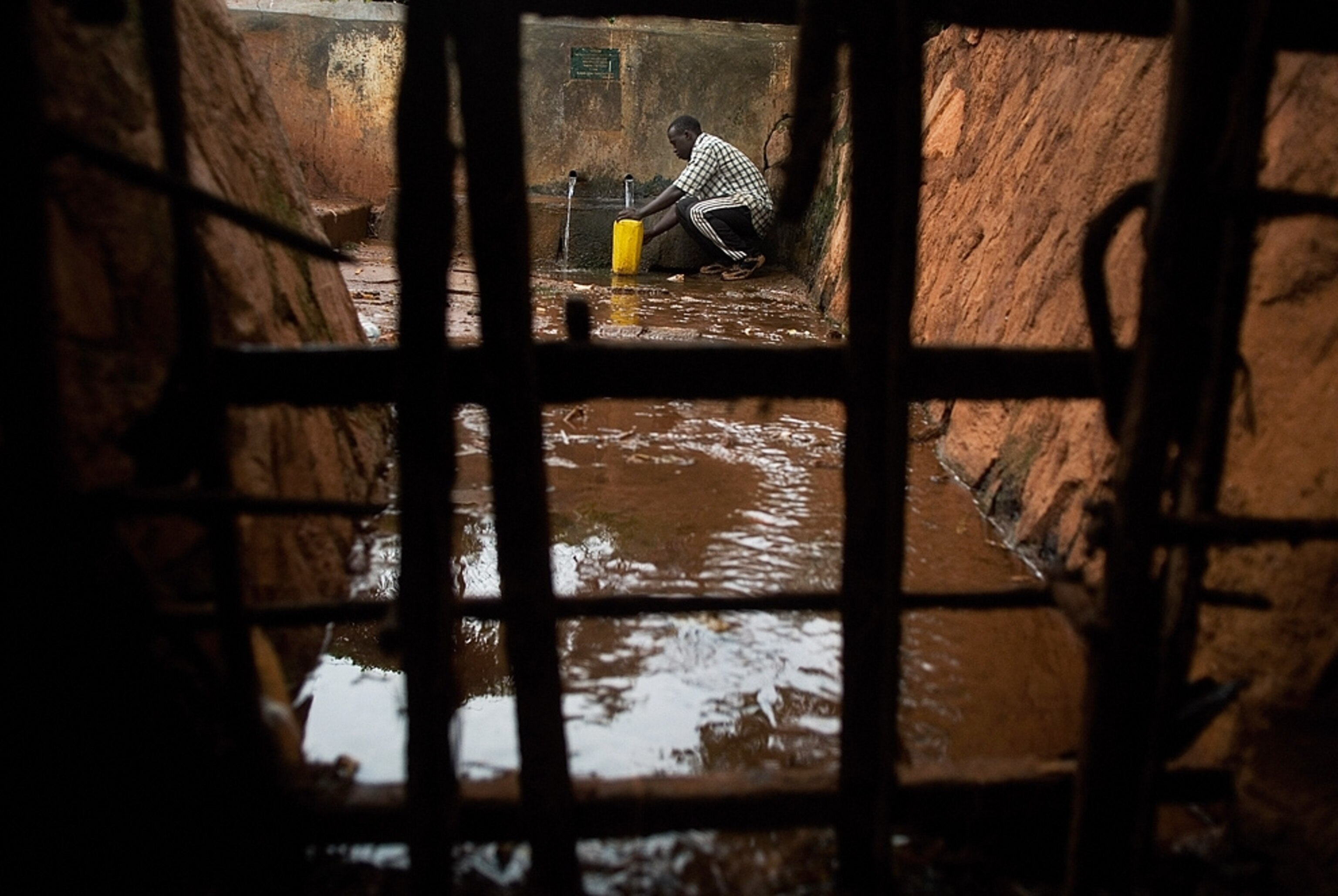 A man fills a jug with water