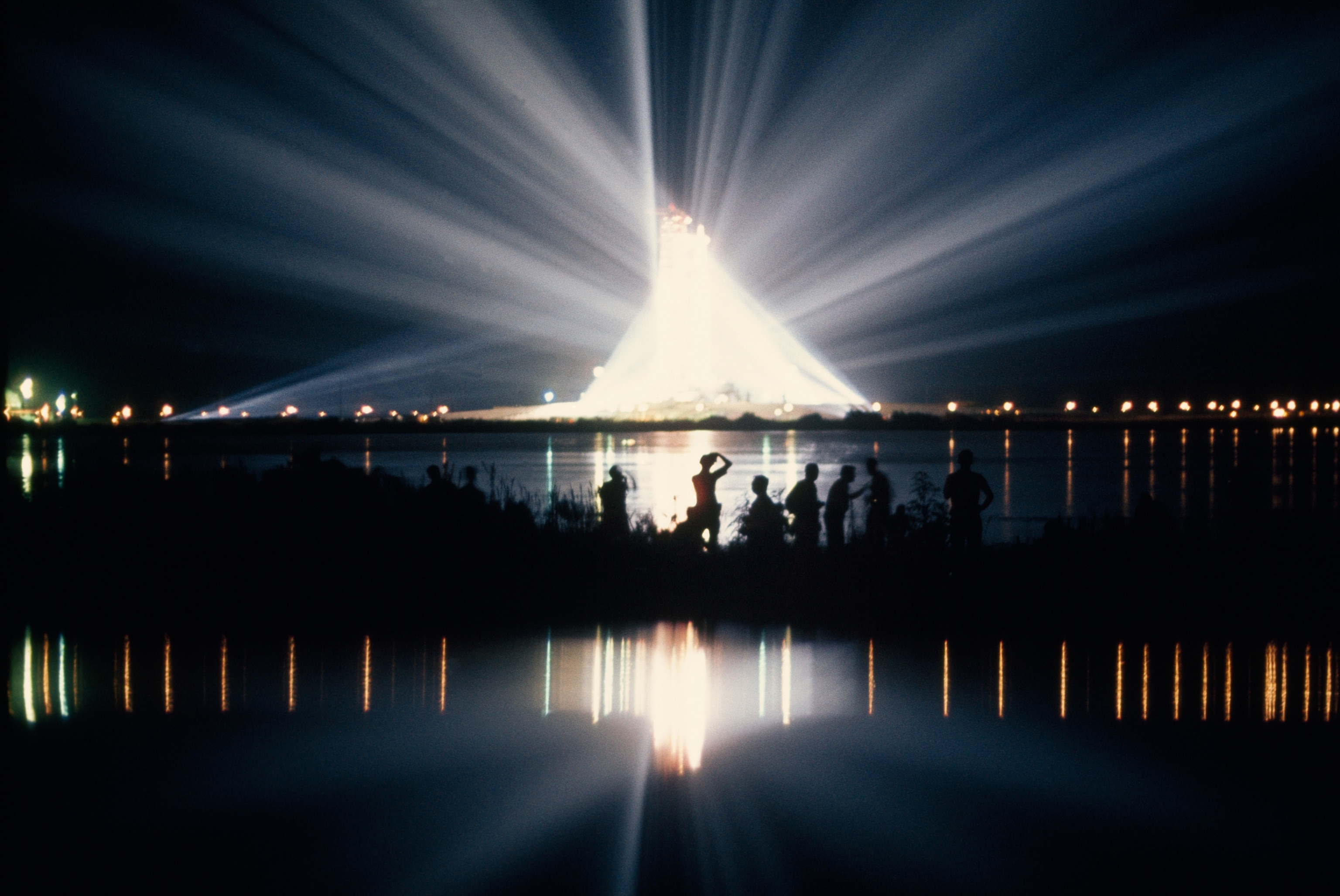 Illuminated by spotlights, Apollo 11 gleams at the Kennedy Space Center, Florida