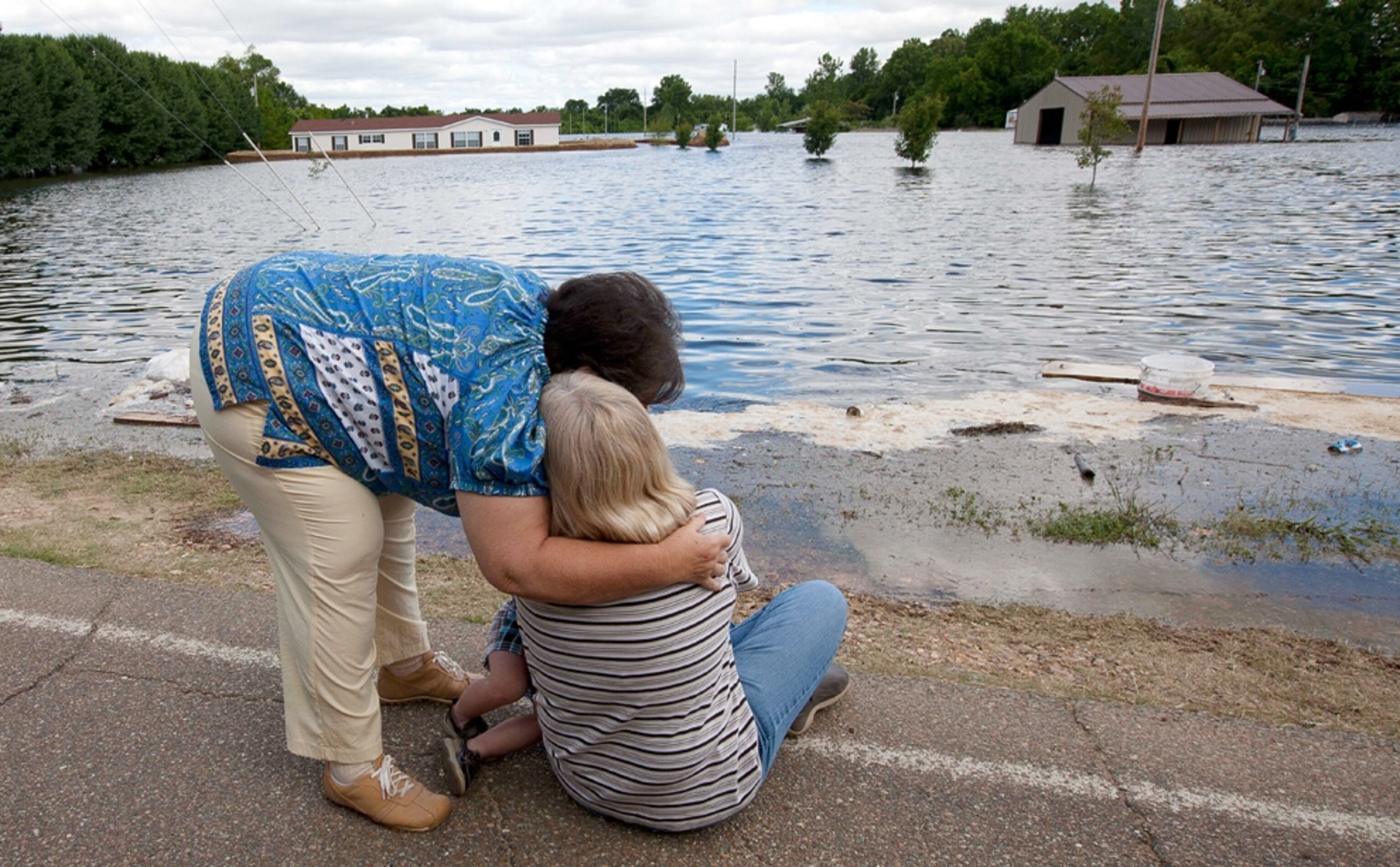people crying on the banks of a river