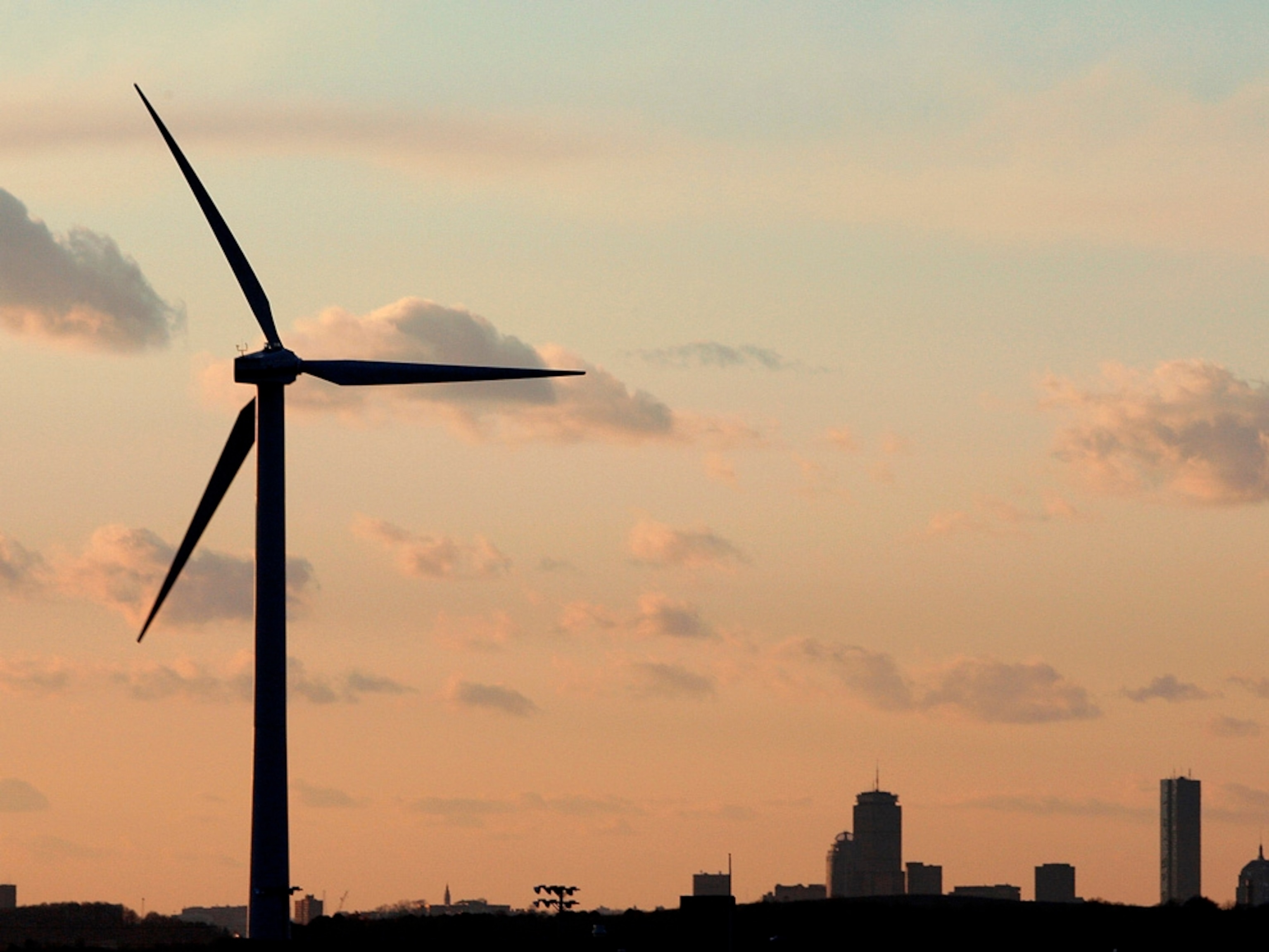 ** FILE ** In this Feb. 24, 2006 file photo, a wind turbine stands generating power next to the Hull, Mass., High School in the shadow of Boston. The Obama administration faces a tough choice in the bitter, long-running fight over plans to build the nation's first offshore wind farm off Cape Cod. Two of President Obama's key allies are on opposite sides: Sen. Edward Kennedy, a leading foe of the project, and Massachusetts Gov. Deval Patrick. (AP Photo/Stephan Savoia, File)