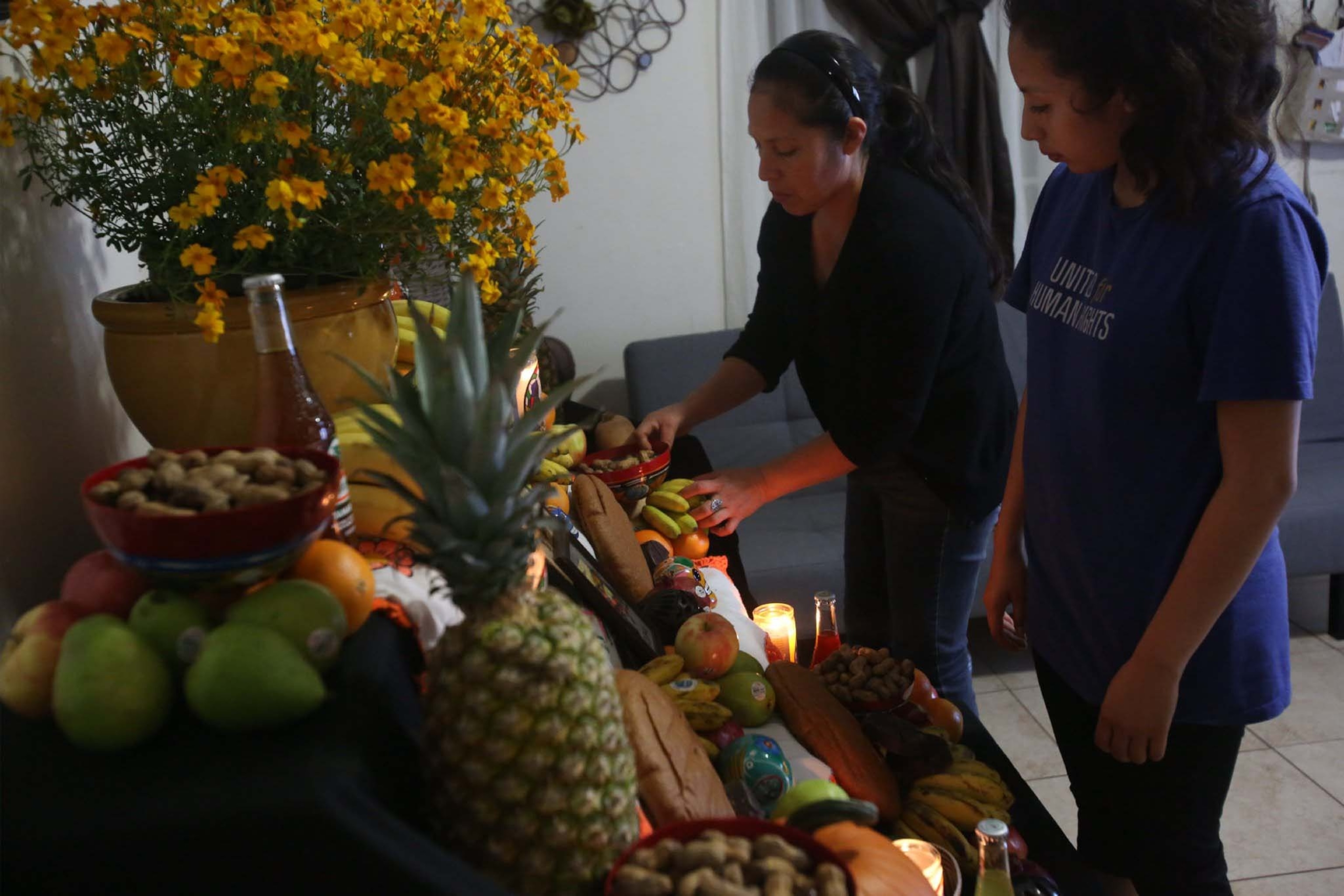 A Oaxacan family makes a home altar for day of the dead