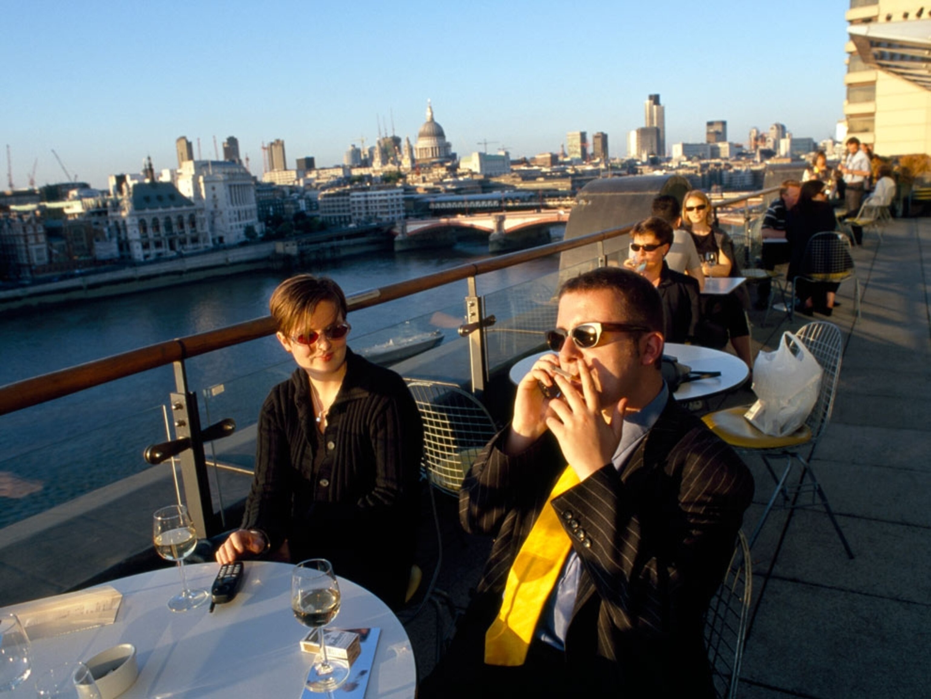 Patrons at a café along a river's edge
