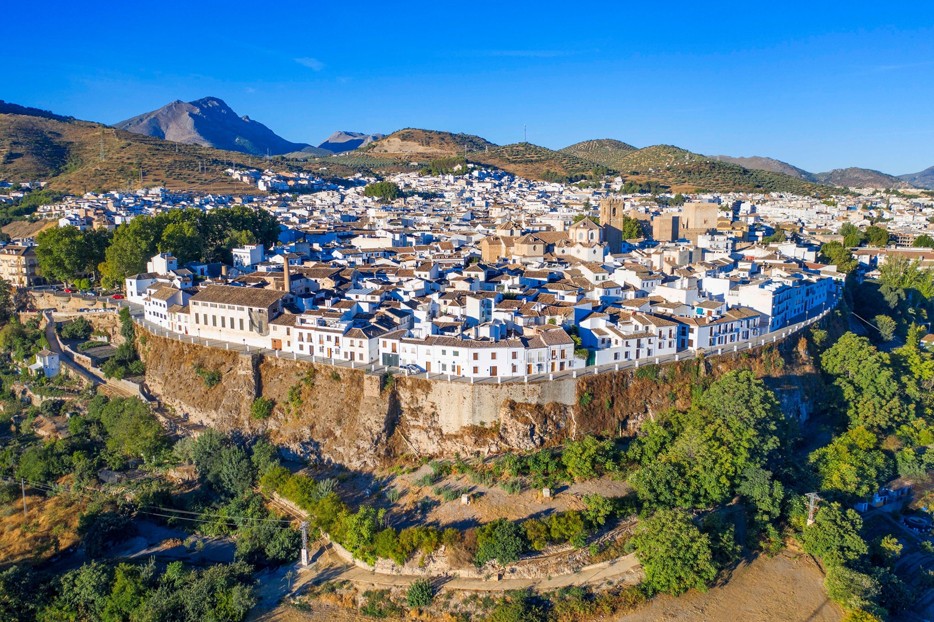 An an aerial view of a town with a cliff face.