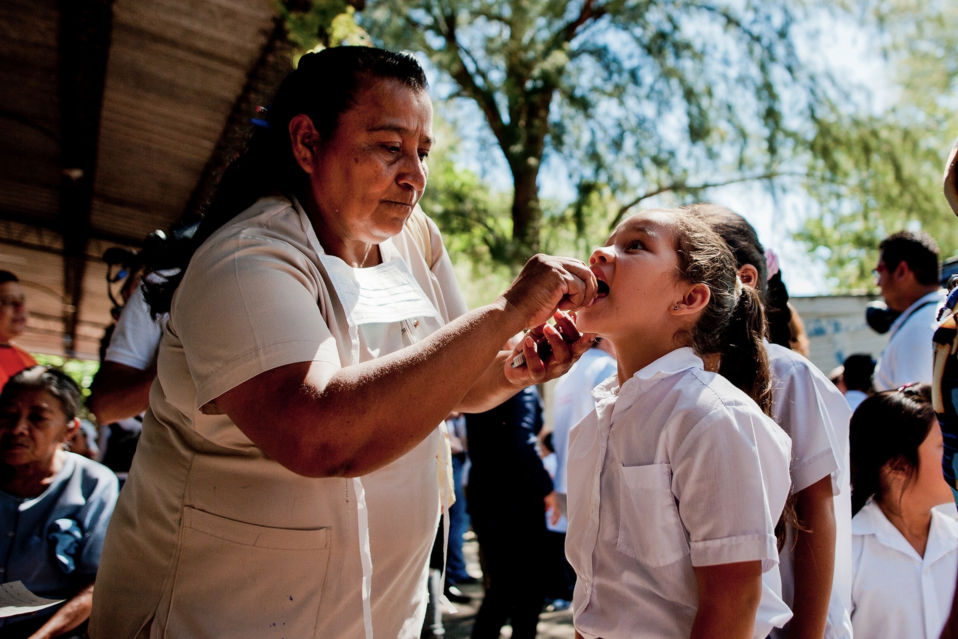 a worker from Haiti's Ministry of Public Health spraying chemicals to exterminate mosquitos to prevent the Chikungunya virus.