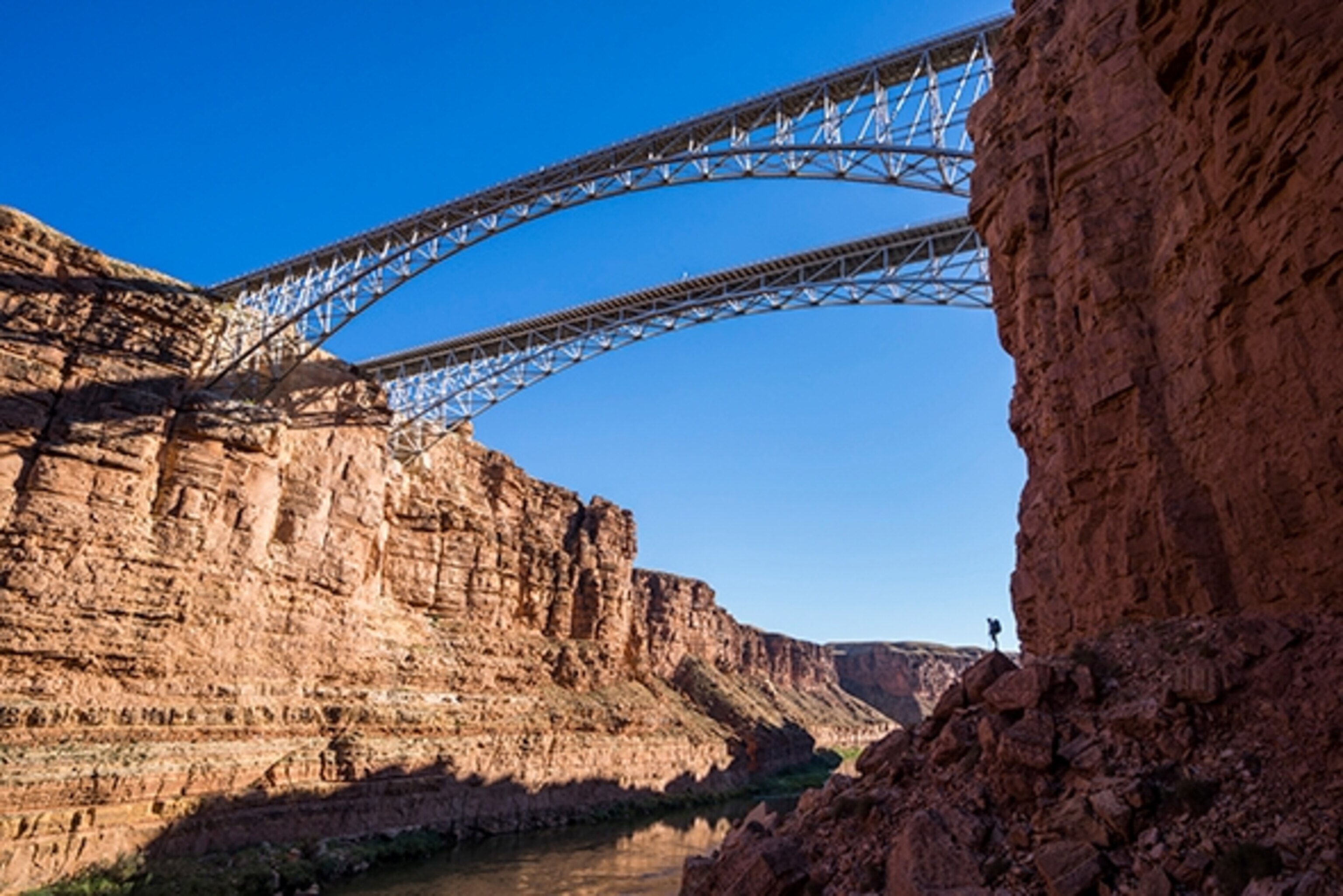 Kevin Fedarko stands below Navajo Bridge inside Marble Canyon on day one while walking the length of the Grand Canyon—over 277 river miles and estimated 600 walking. Photograph by Pete McBride