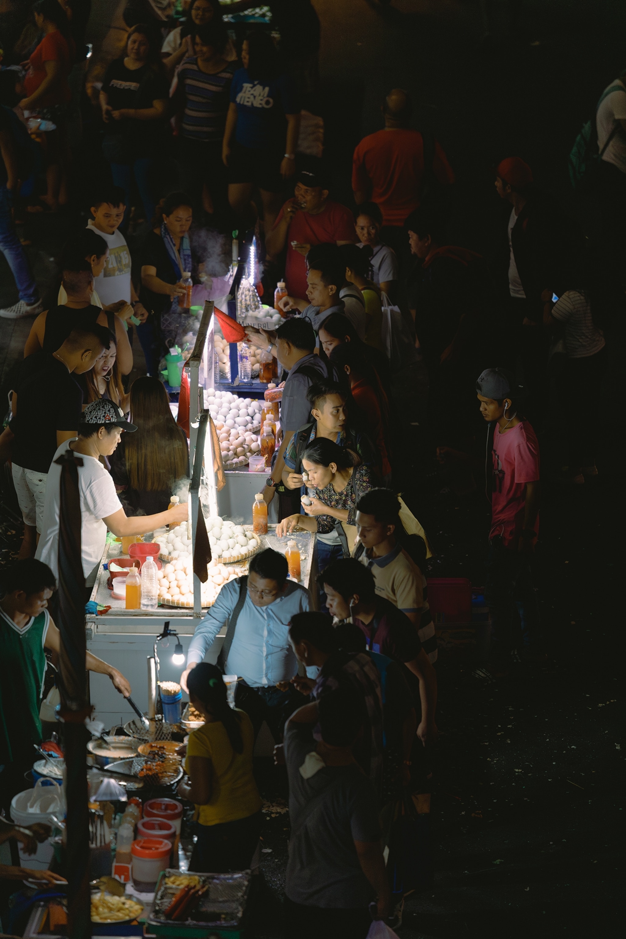 A rush hour view in Manila as people eat balut or a fertilizer duck egg at the street side. Balut is a popular street food in the Philippines. Some people eat this for fortitude before a physical labor and some consider it as a right of passage to Philippine cousin tourism.