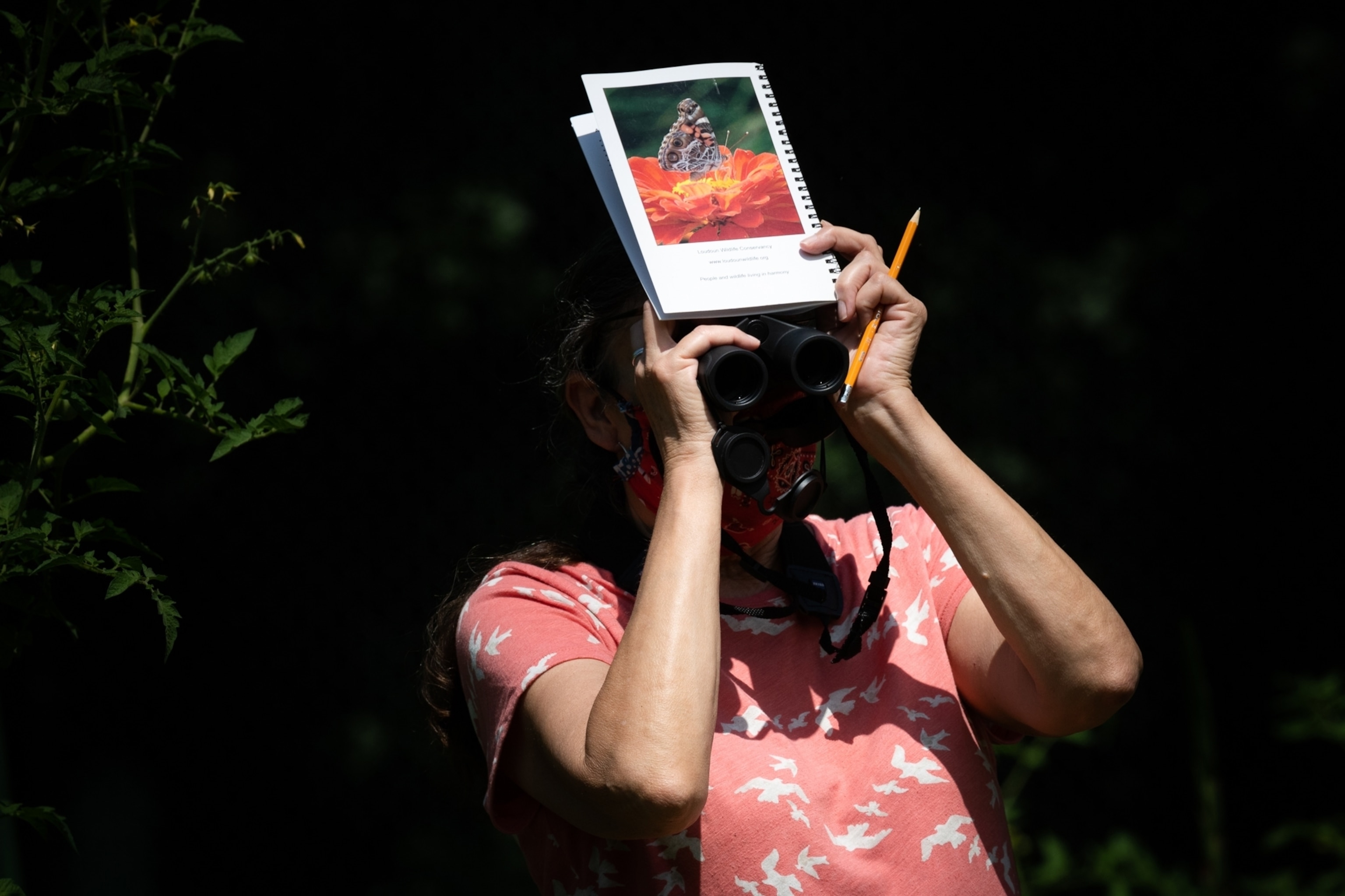 a woman looking through binoculars