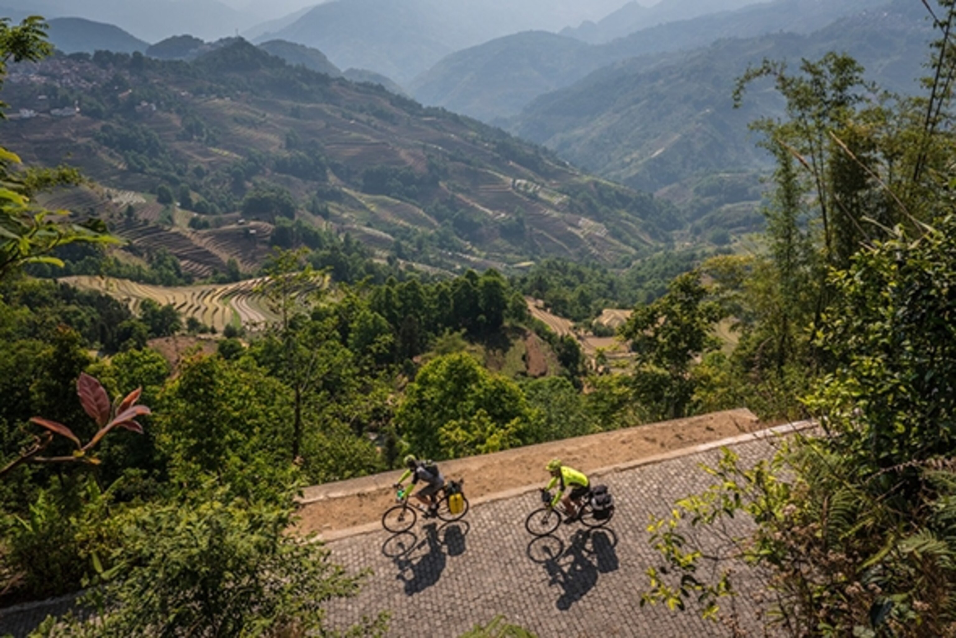 Kyle Hemes and Stew pass through a mosaic of rice terraces and mountains, part of the Yuanyang UNESCO World Heritage site; Photograph by Will Stauffer-Norris