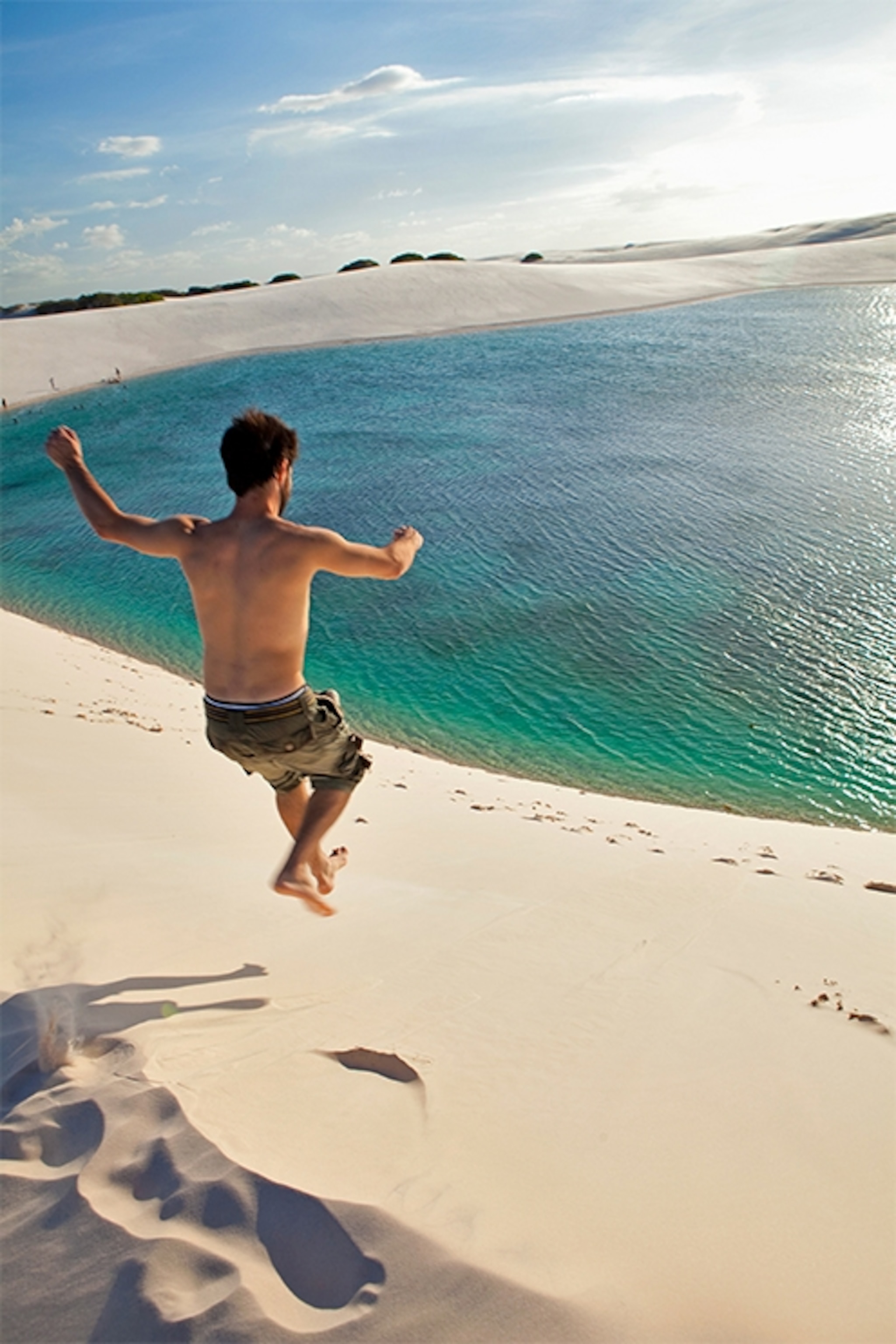 person jumping off dunes in Lençóis Maranhenses National Park, Brazil