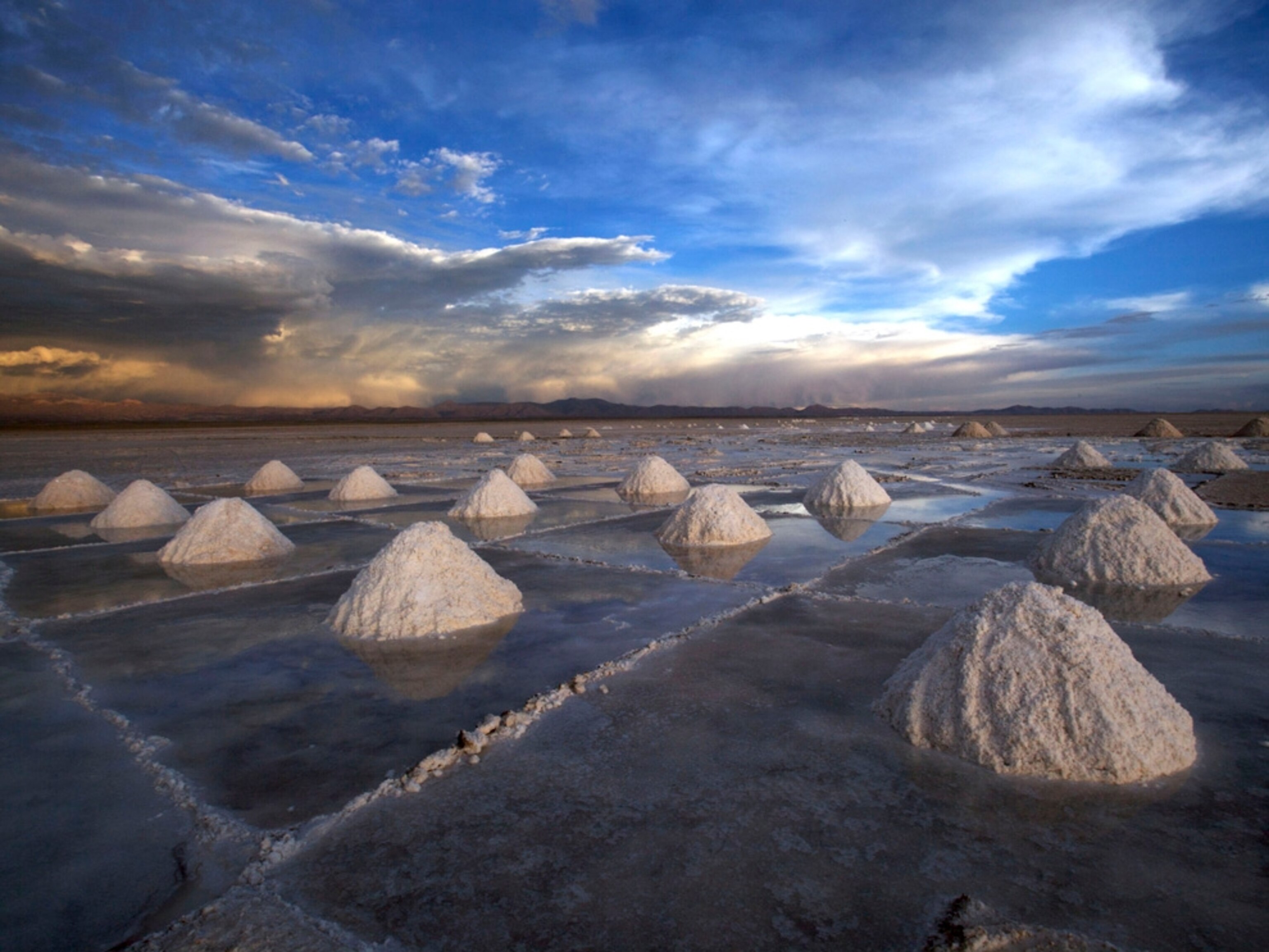 Extracted salt sits in piles at the Uyuni Salt Flat in Uyuni, Bolivia, on Nov. 18, 2009. The salt flat is also the world's largest untapped lithium reserve, containing enough of the lightest metal to make batteries for more than 4.8 billion electric cars. Photographer: Noah Friedman-Rudovsky/Bloomberg via Getty Images