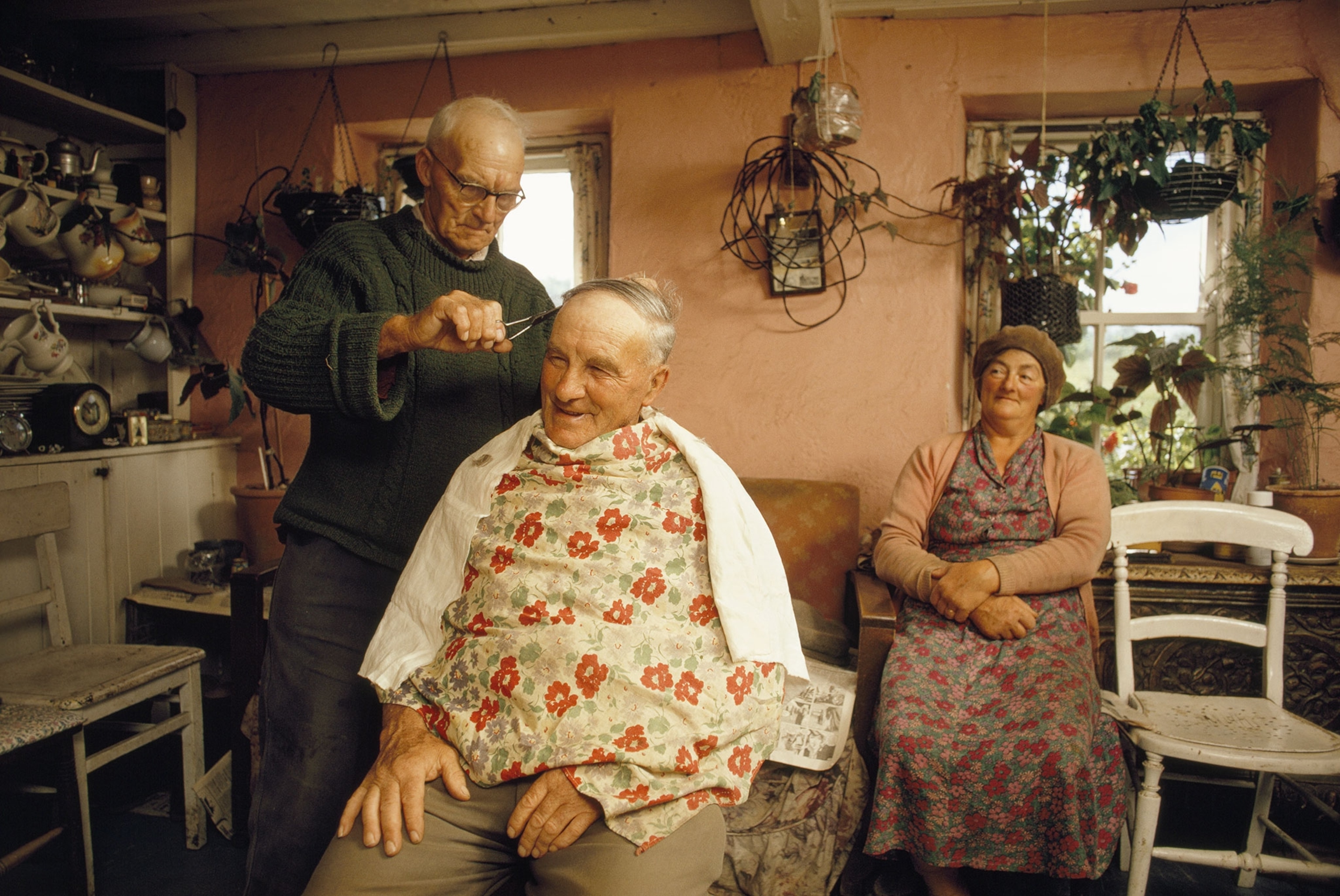 man having hair cut in kitchen