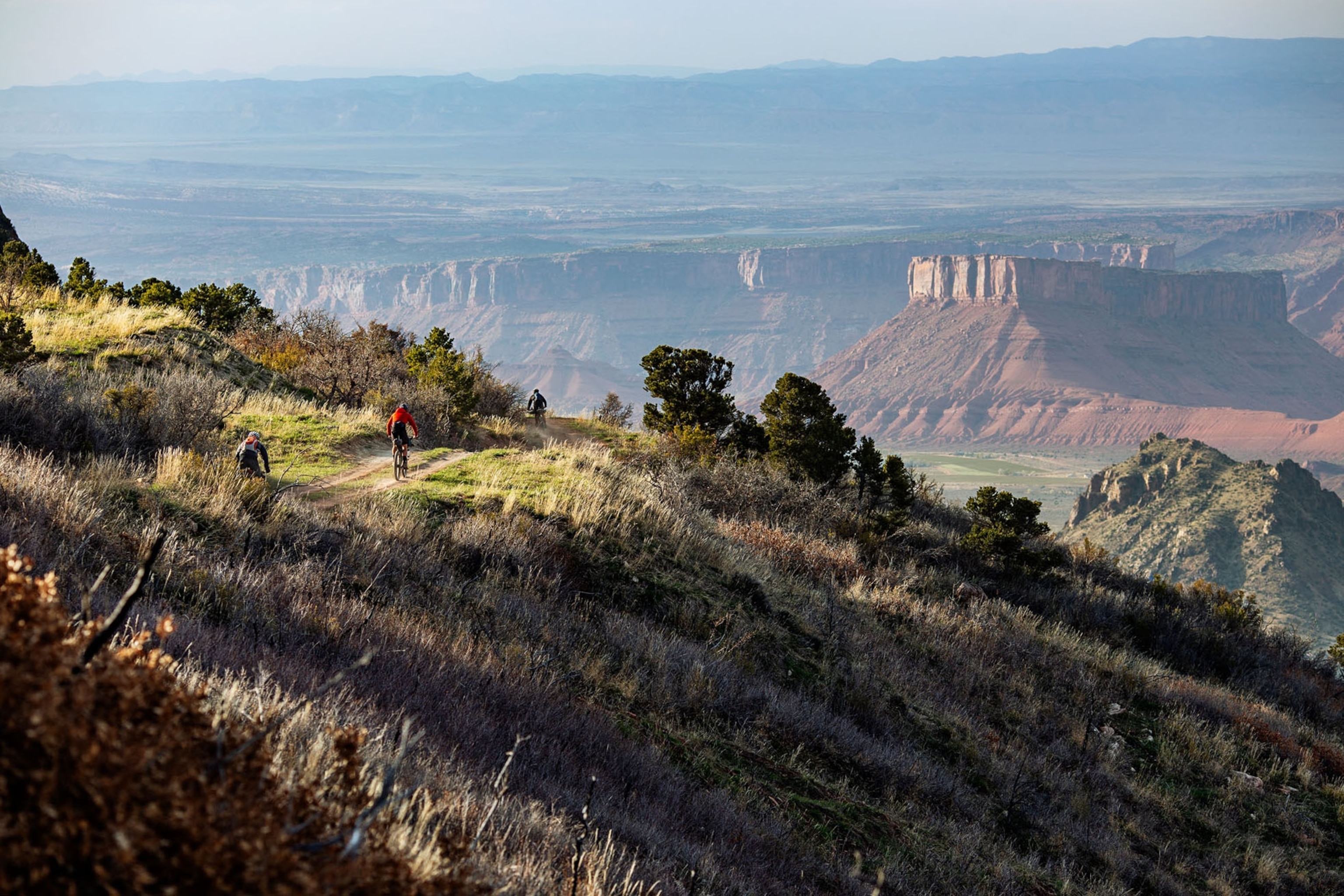 a group of bikepackers on the kokopelli trail in Utah at dusk
