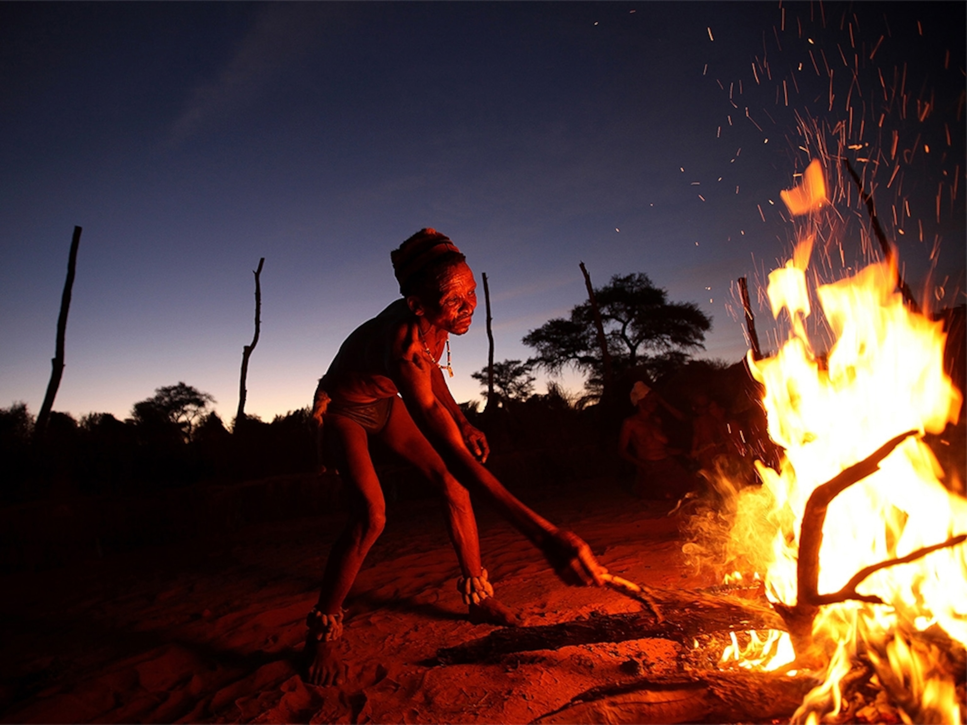 San bushmen around a fire in the Kalahari in Botswana