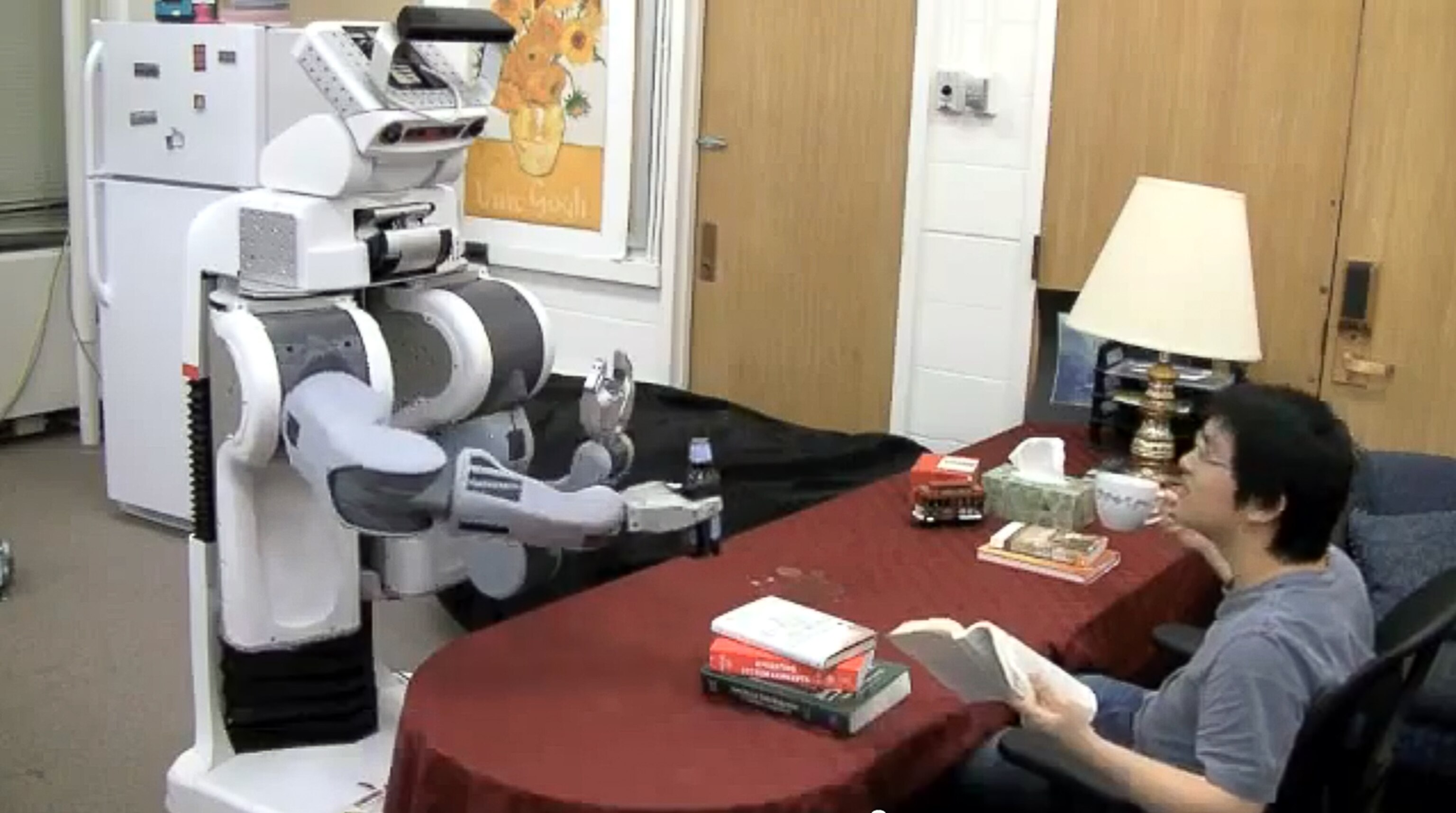 A robot prepares to pour a beer.
