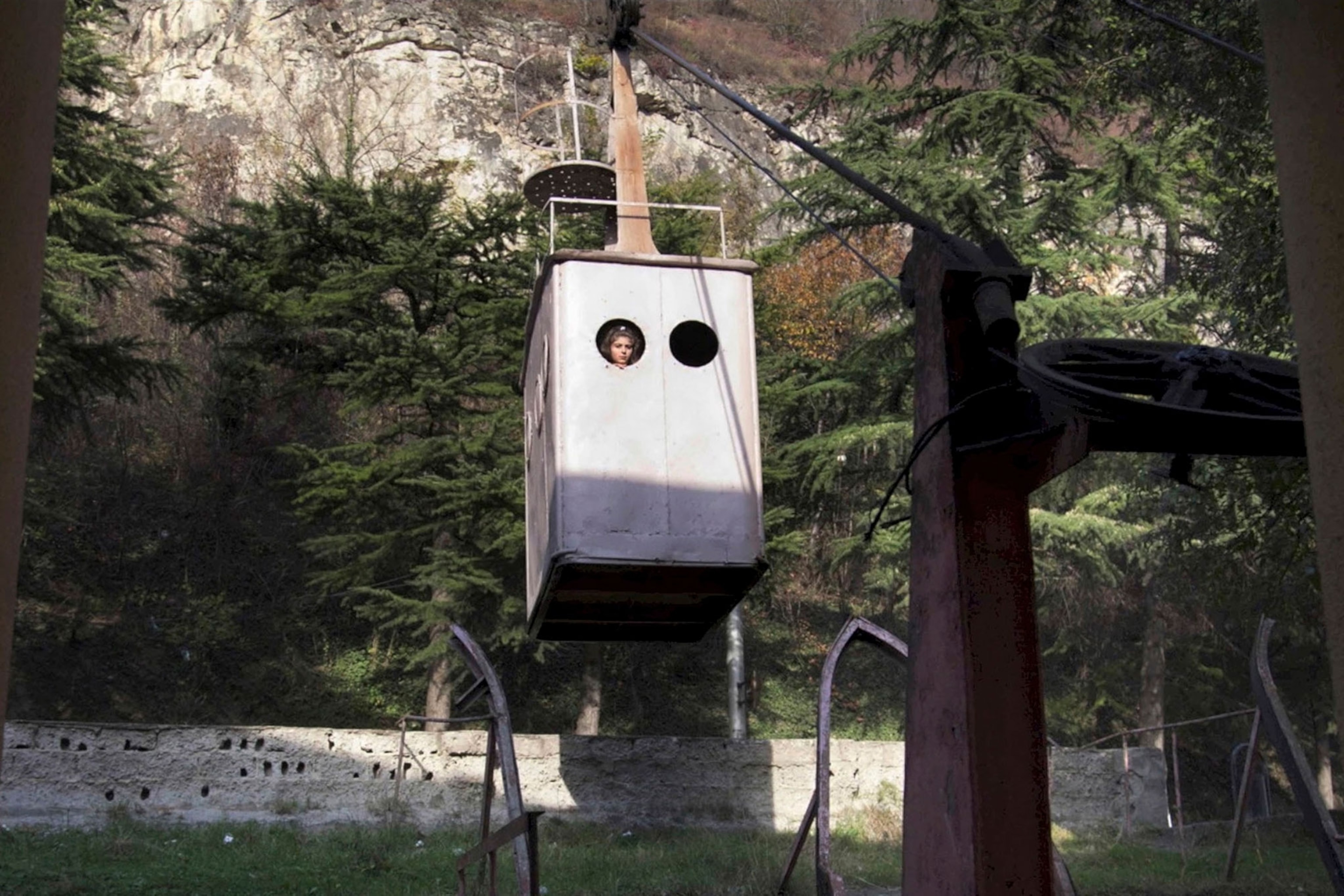 a woman riding a cable car in Chiatura, Georgia