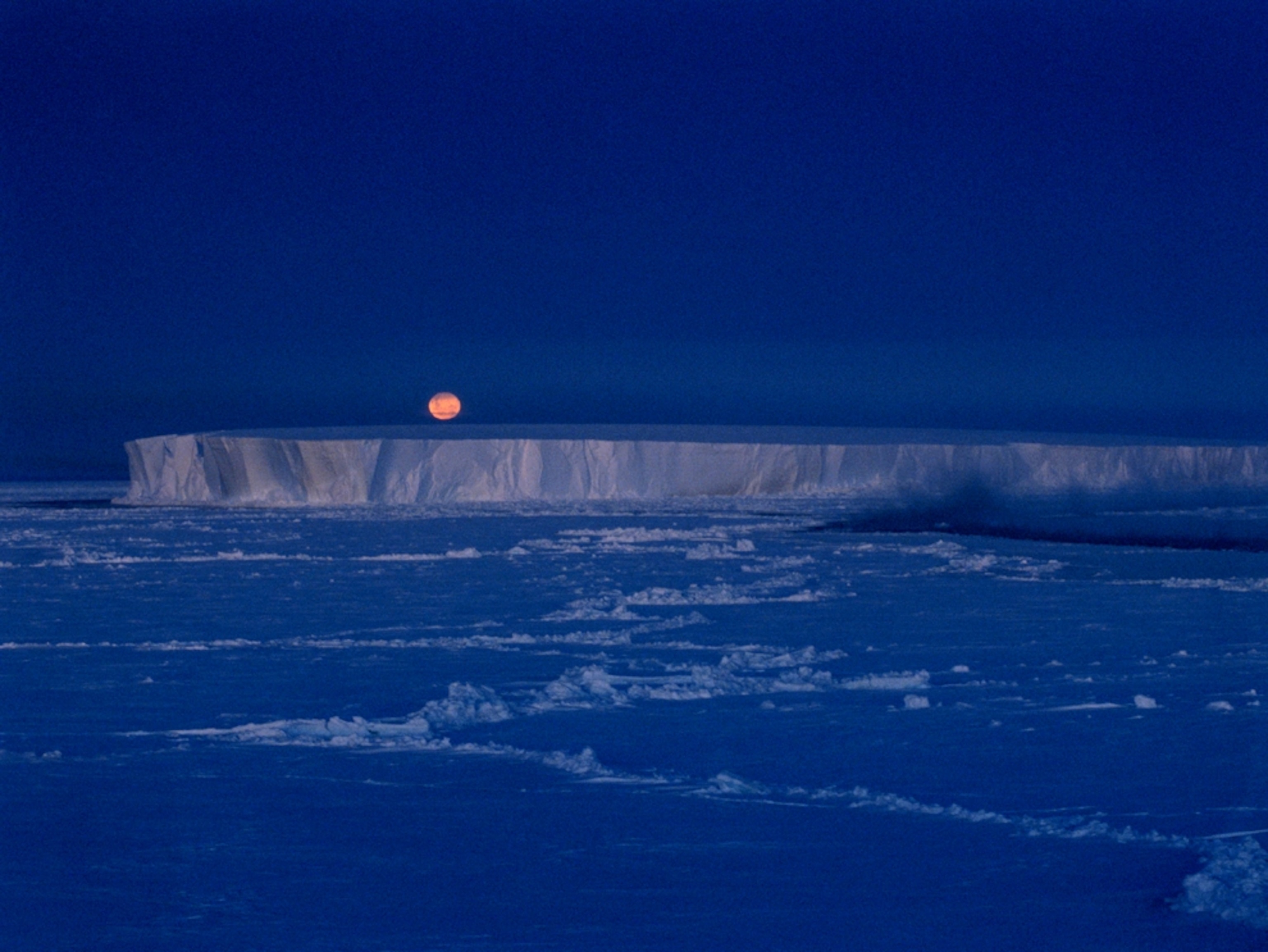 The moon rises over an iceberg in the Bellingshausen Sea