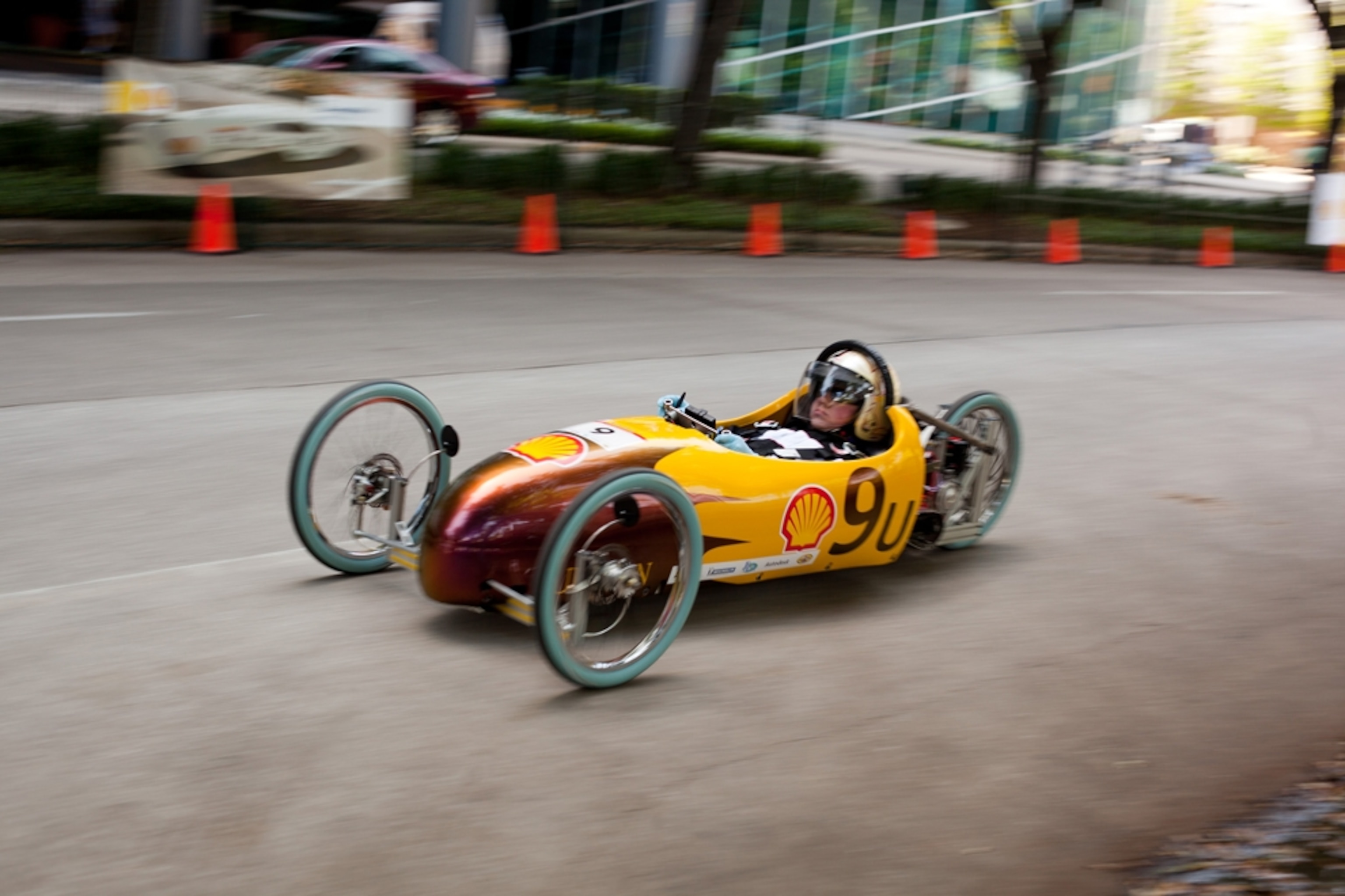 Low-slung yellow vehicle with three wheels