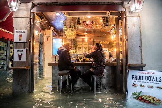 Locals pause for a drink despite the high water.