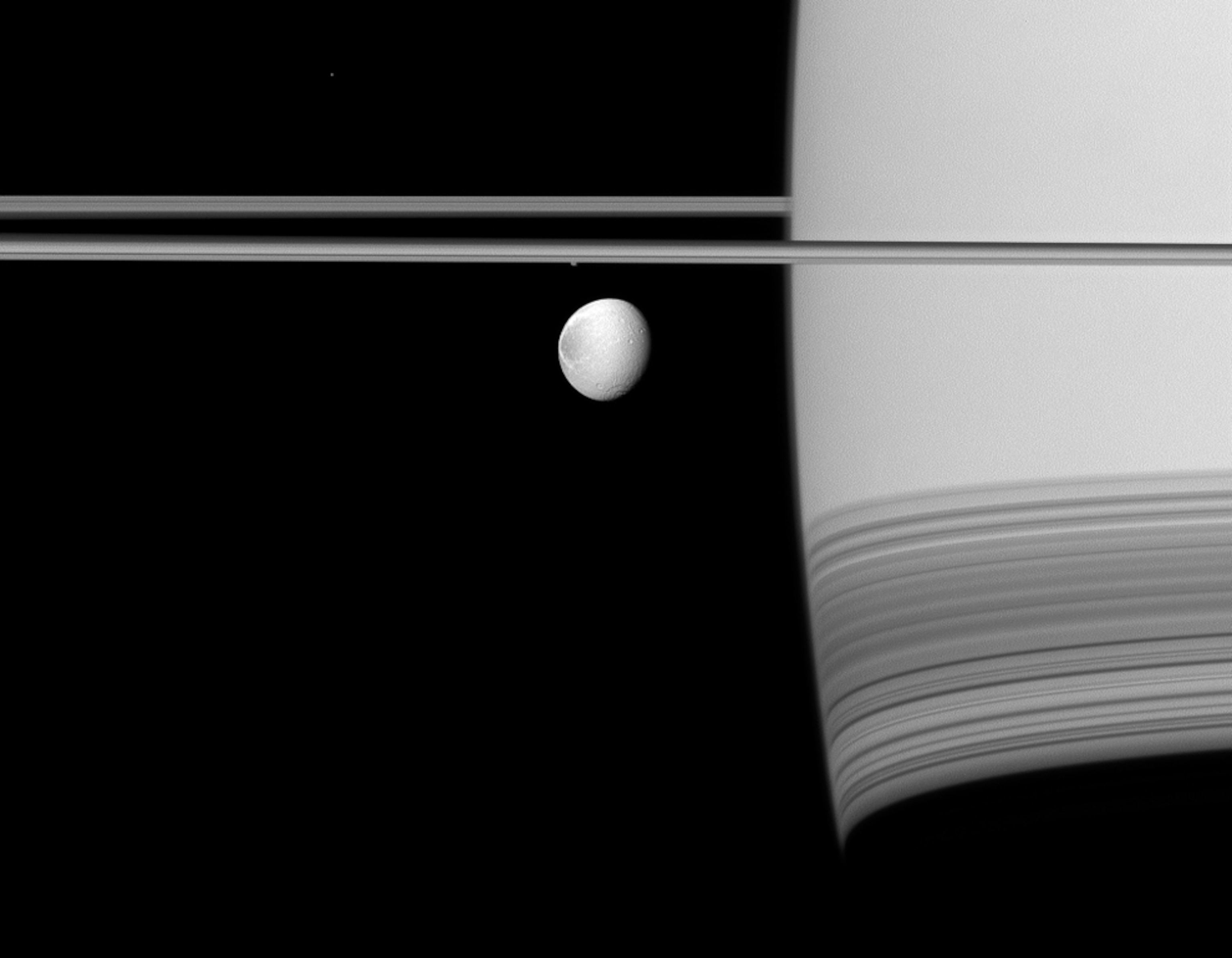 Saturn's moon Dione seen under the planet's rings