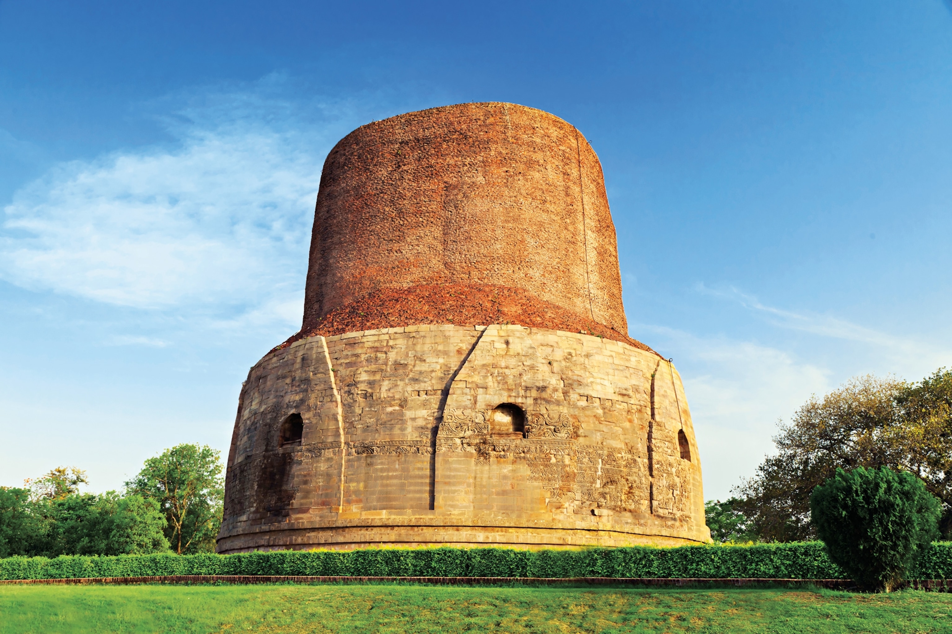 The reddish Dhamek Stupa structure in Uttar Pradesh, India