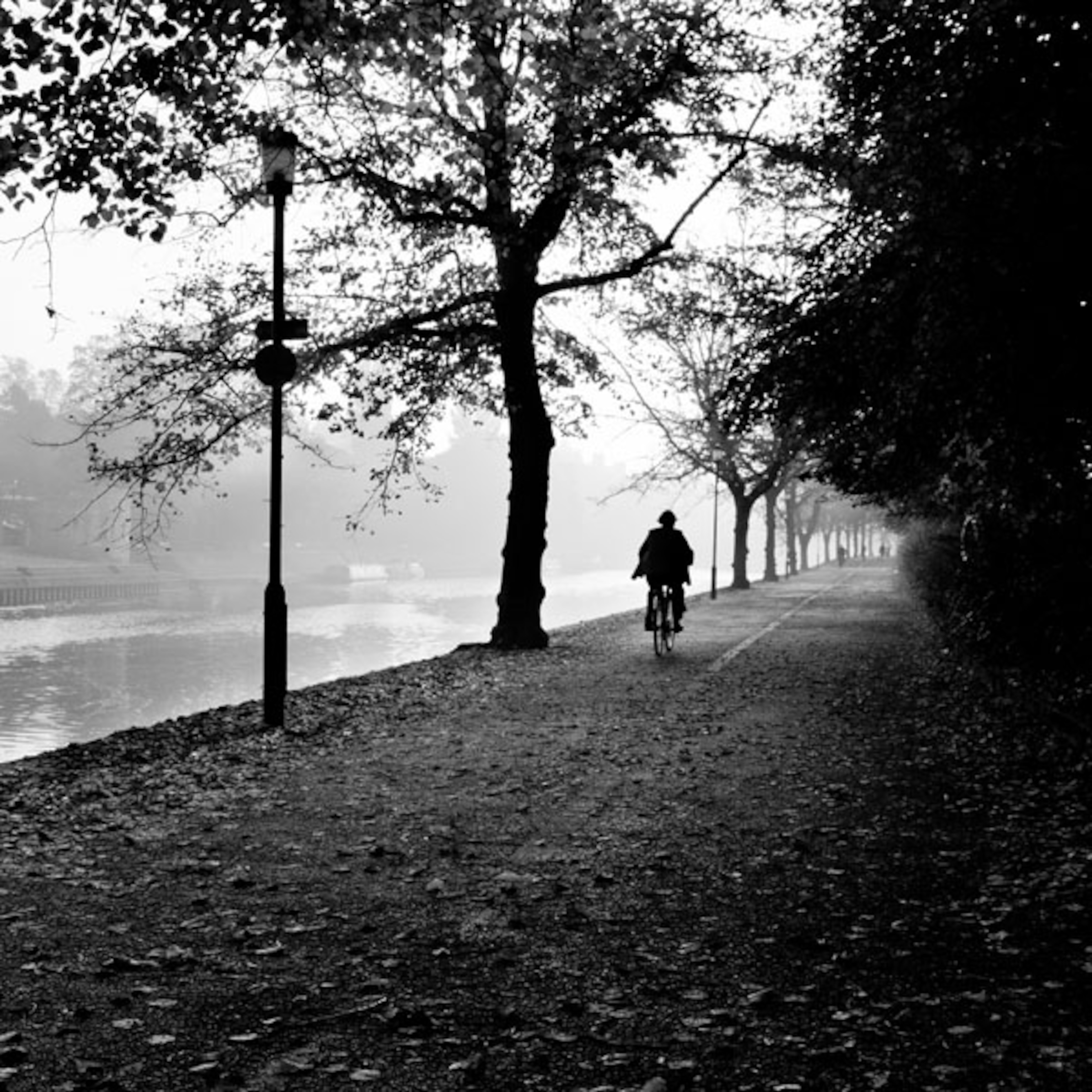 A bike rider near a river in York, England