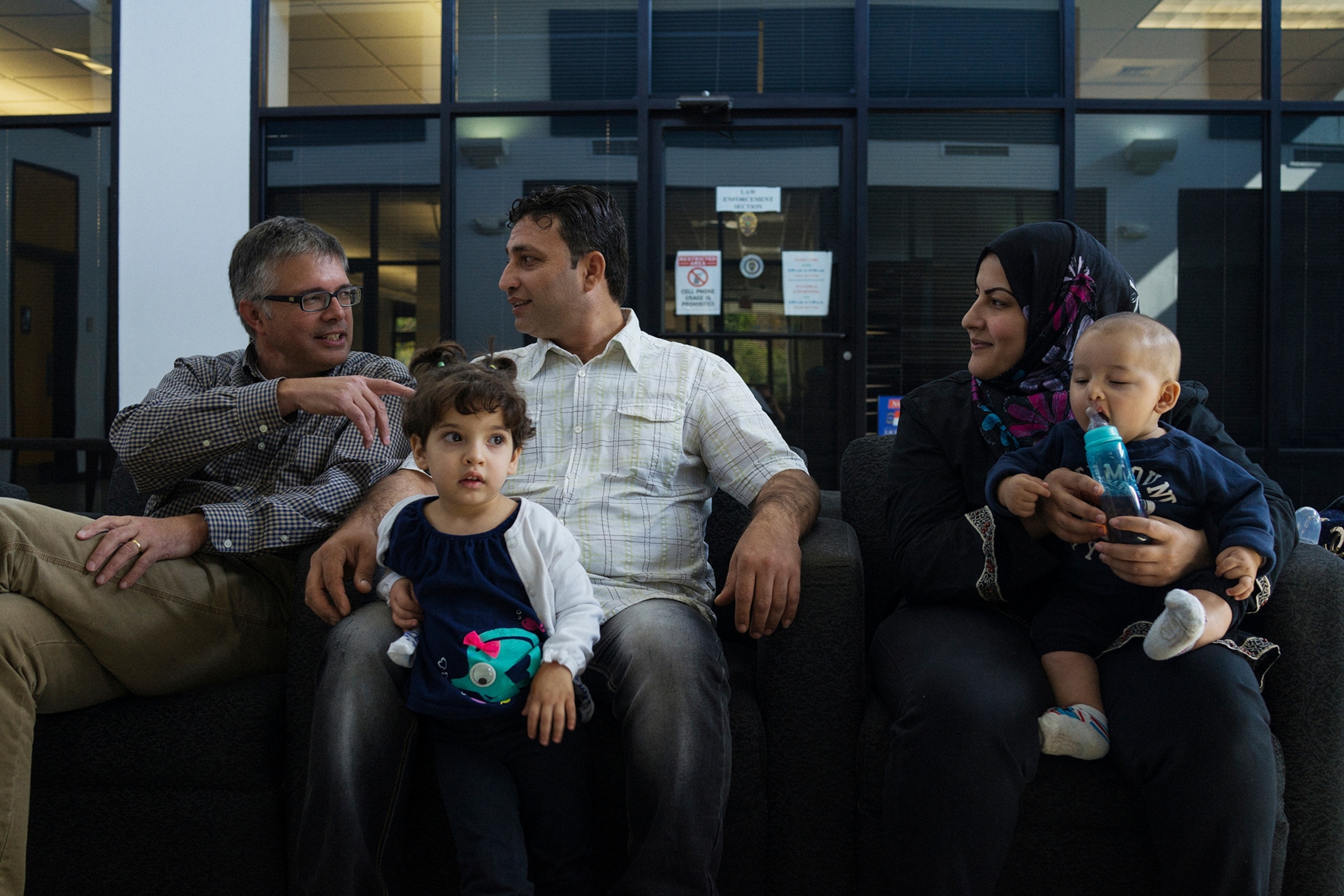 a Syrian family waiting for identification cards at the Division of Motor Vehicles