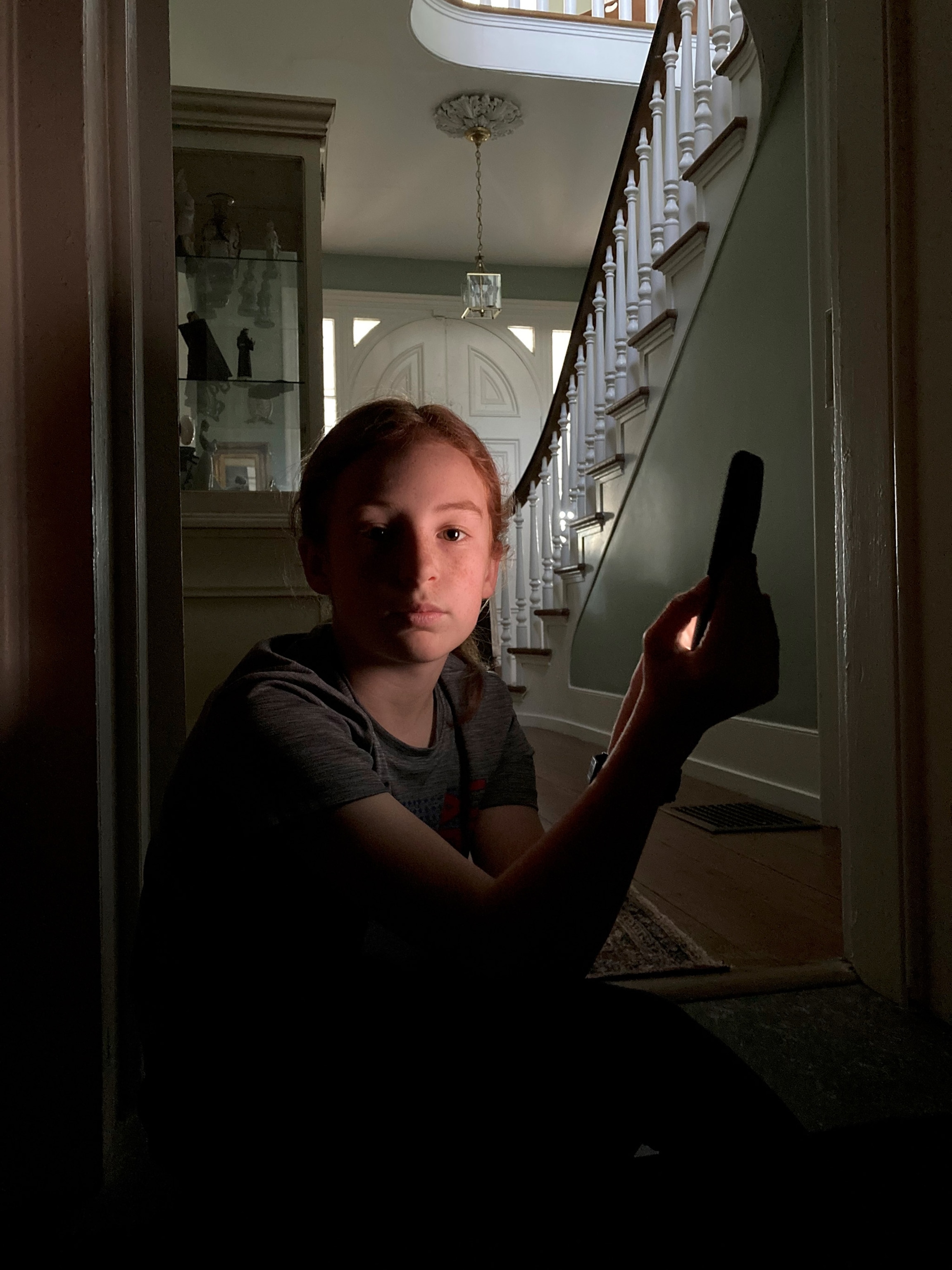 a person with their face lit by a tablet as a continuous light source