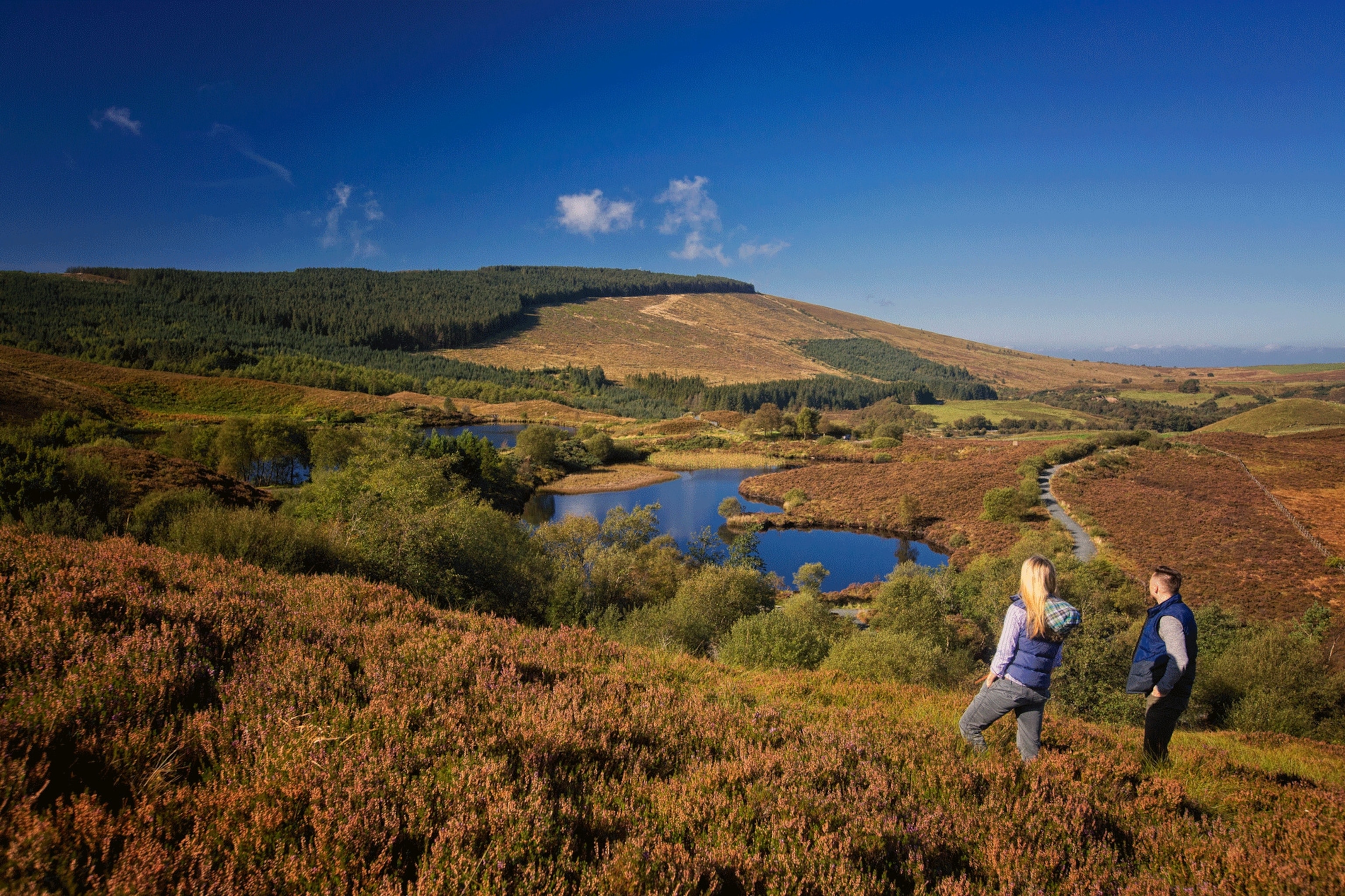 Hikers admire the views over the twin pools of Gortin Lakes in County Tyrone.