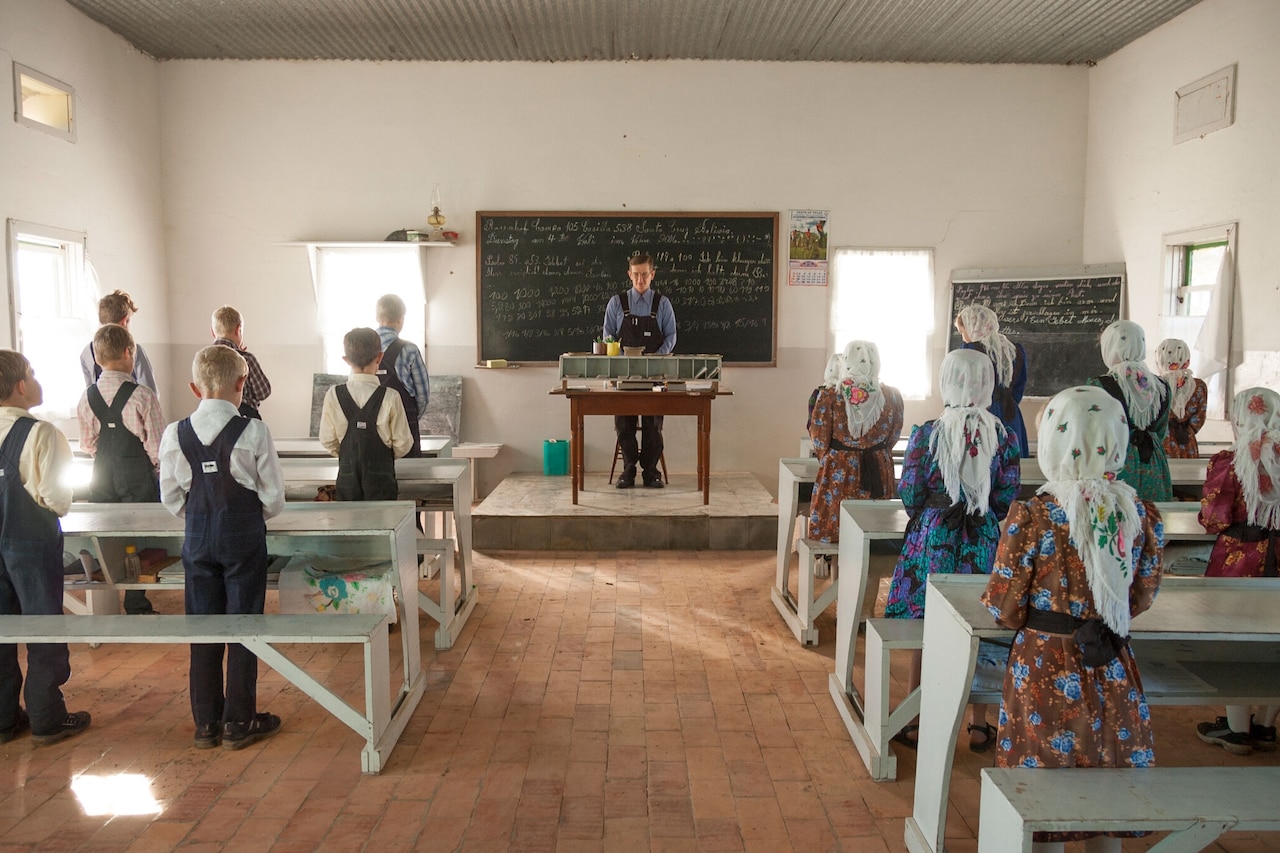 A prayer starts the day in Franz Petters' classroom. Children attend school from ages six to 13 years old. Girls sometimes leave a year earlier if they have begun menstruating unless their father agrees they can stay. The curriculum includes math, writing and reading in Low and High German, and religion. With the exception of one modern colony, Busqué says, they do not study science, history, or literature. Colonia Swift Current, Bolivia. 2006