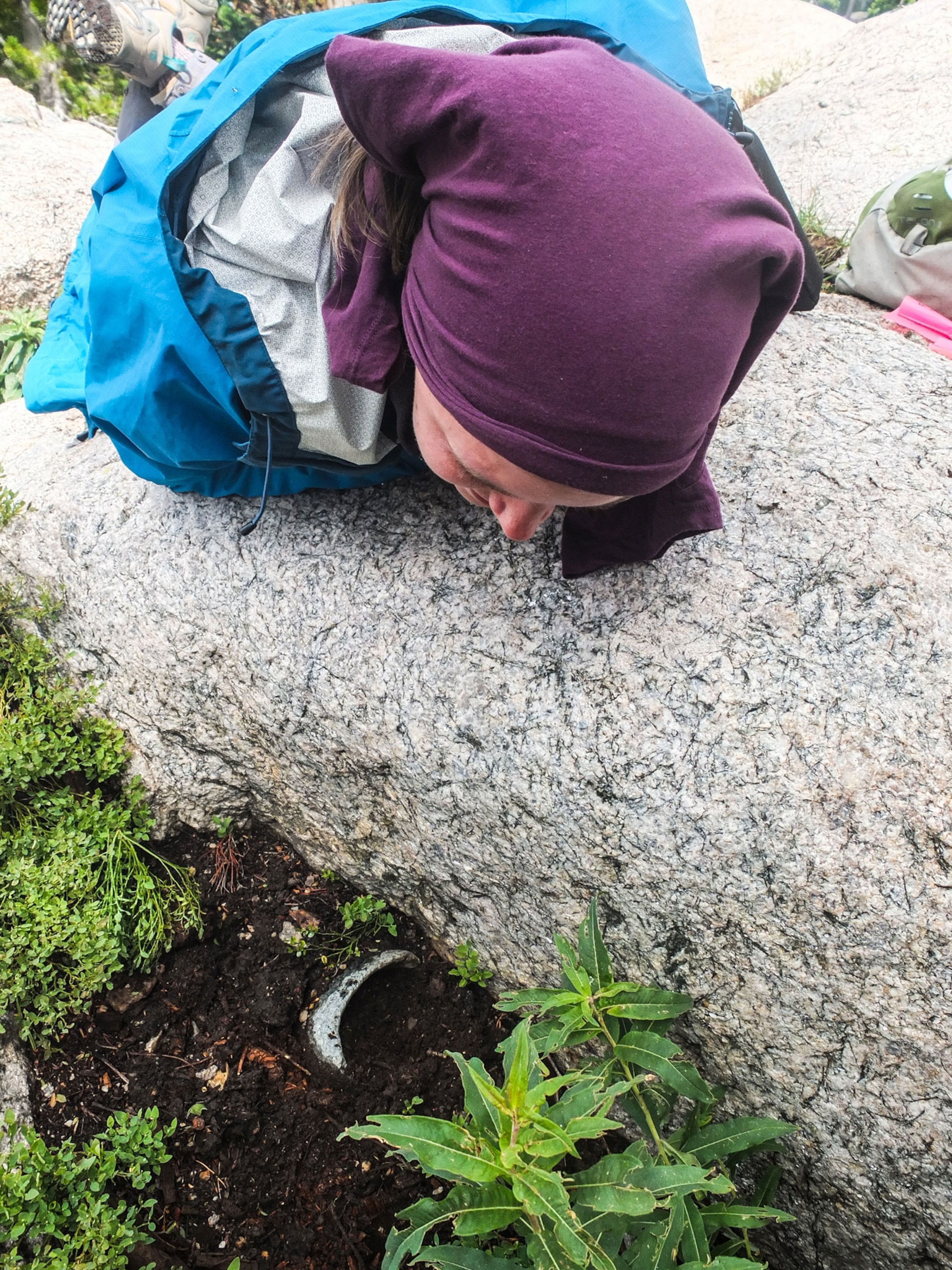 Liza Court peering down at a cached soapstone bowl