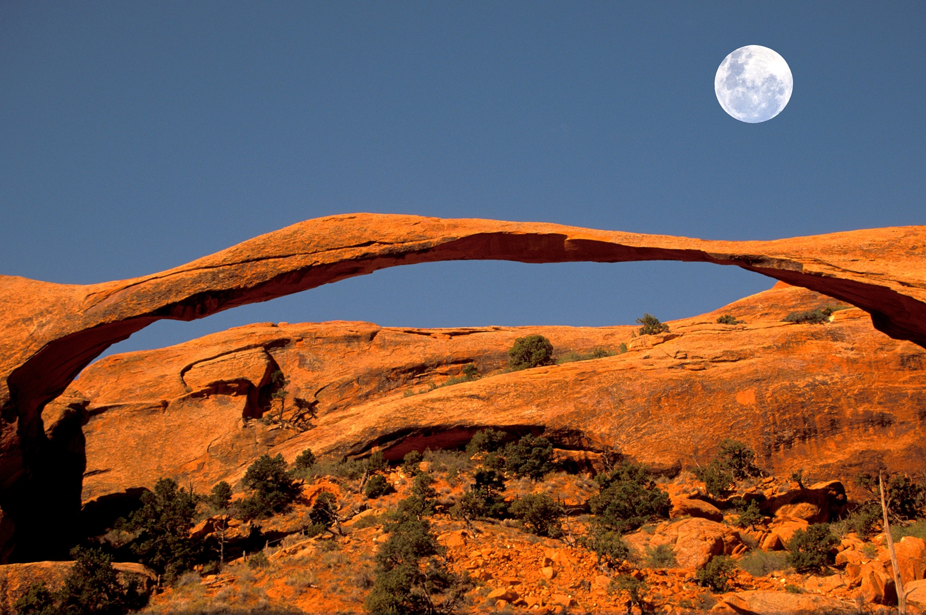 full moon over Landscape Arch in Arches National Park, Utah