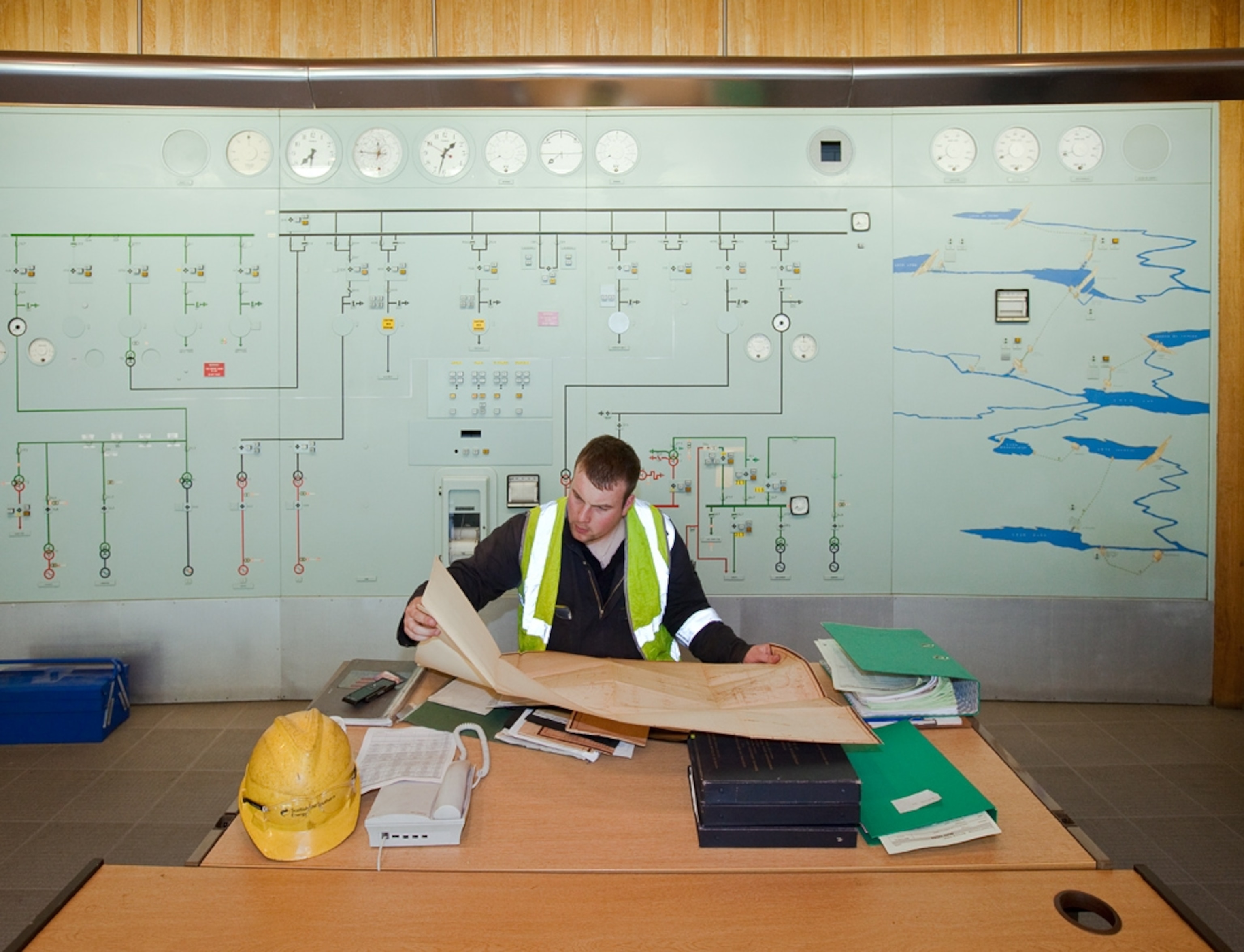An engineer studies diagrams at Lochay Power Station, Scotland