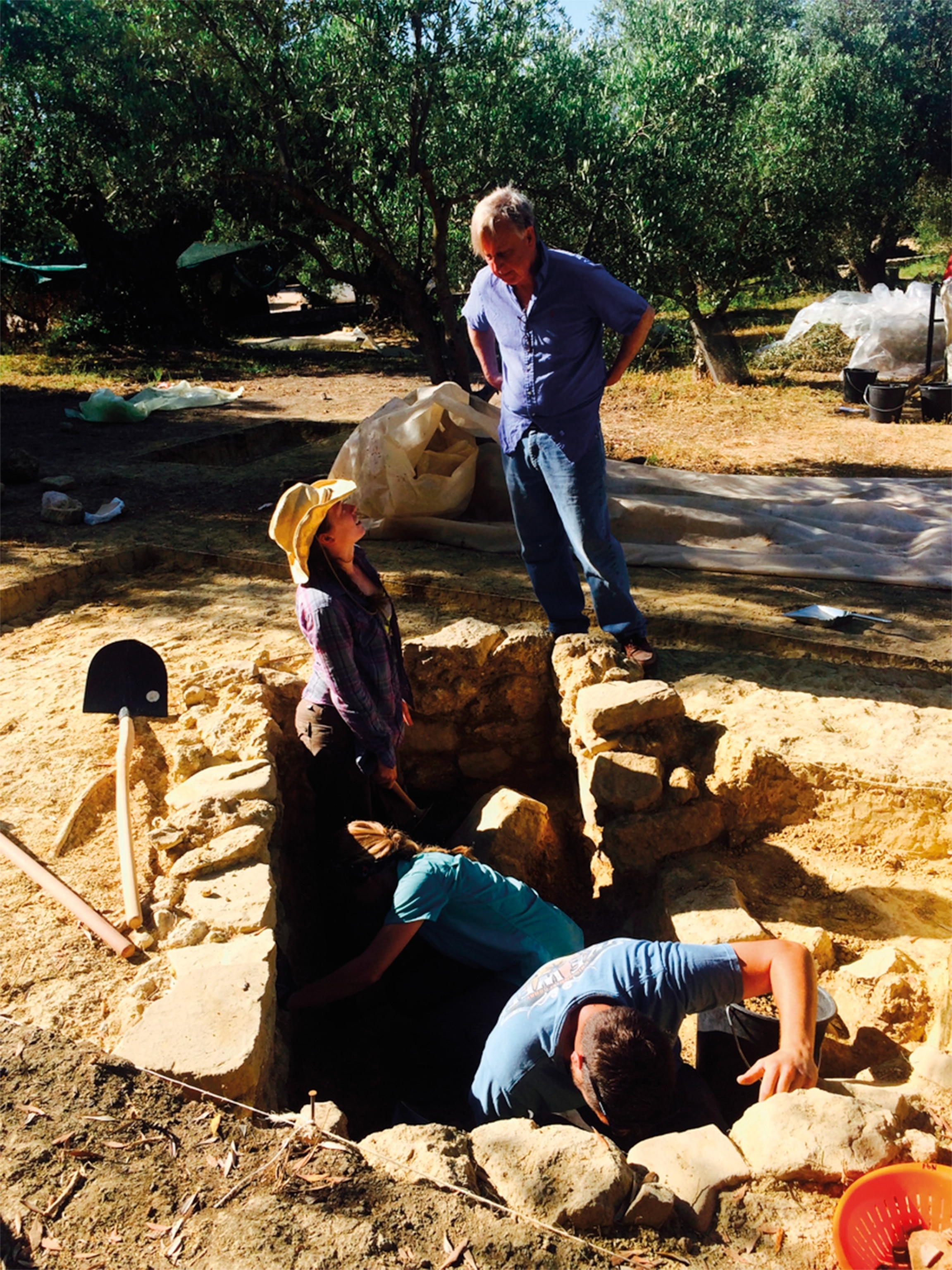 Stocker, on the left, and Davis are pictured on site at the Griffin Warrior's tomb near Pylos, Greece.
