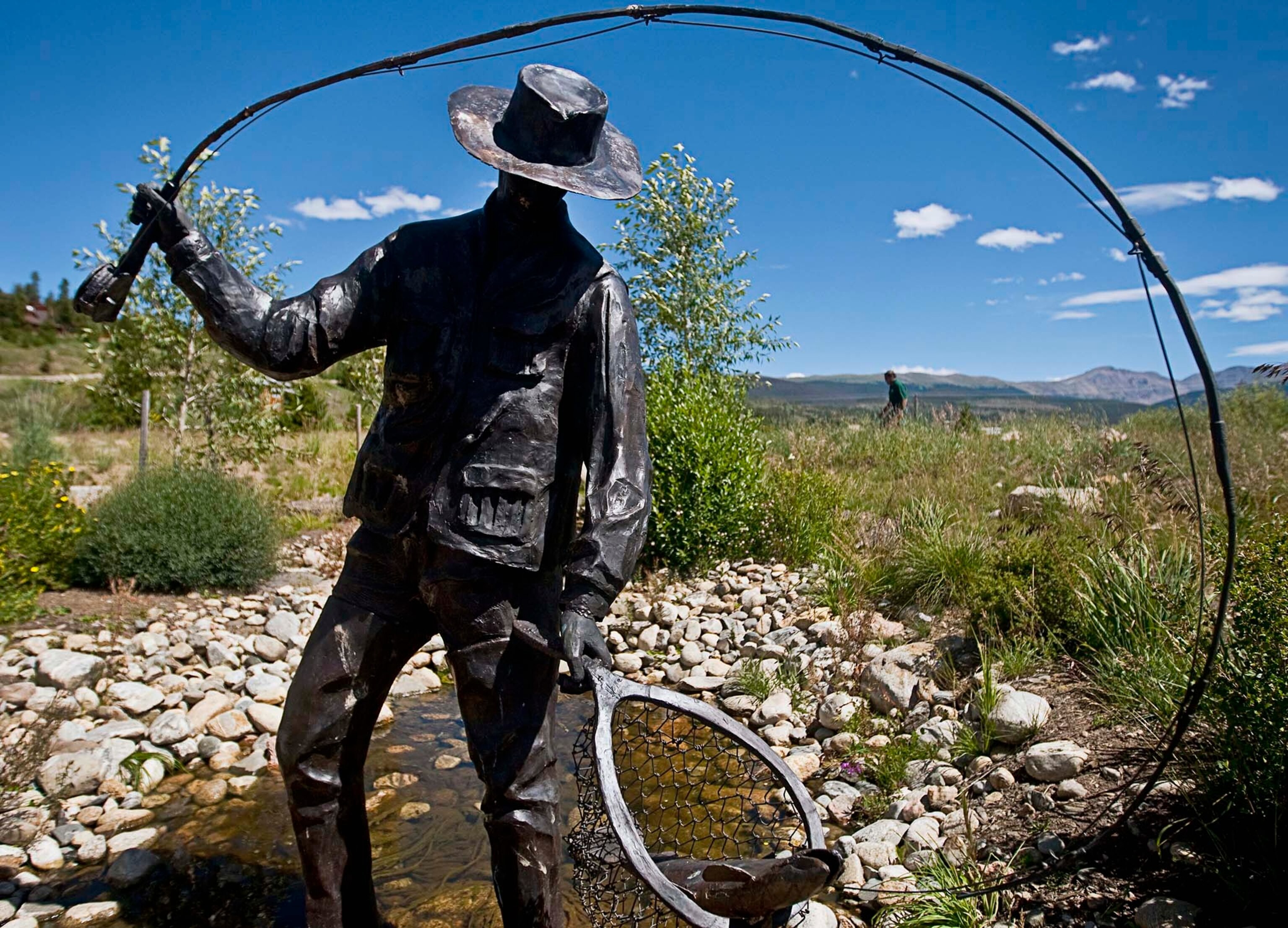 Pres. Dwight D. Eisenhower watching 7-yr-old grandson David fish as they stand at end of rickety pier, on Fraser River at Byers Peak Ranch.