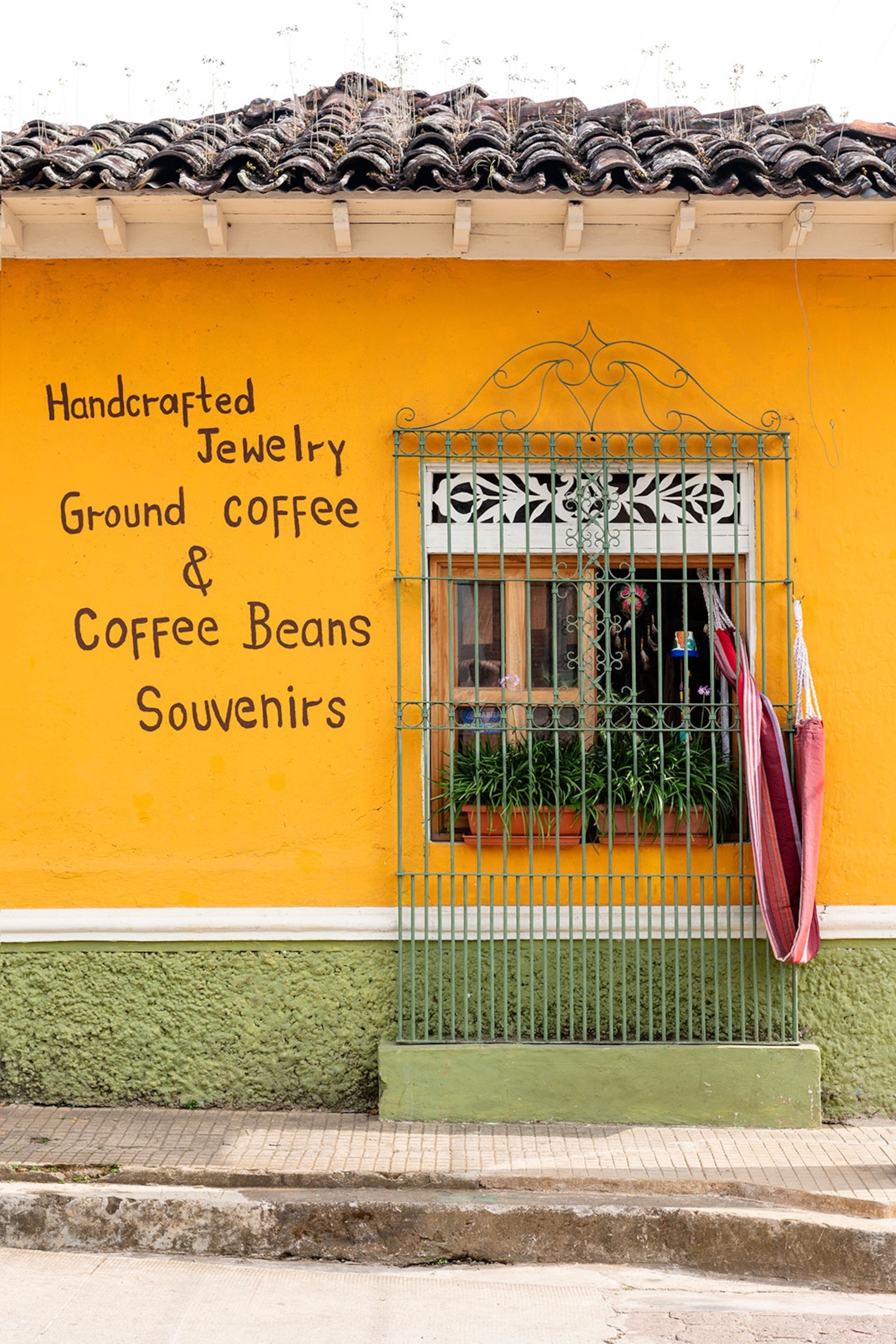 A bright orange building selling jewellery, coffee and souvenirs in El Salvador.