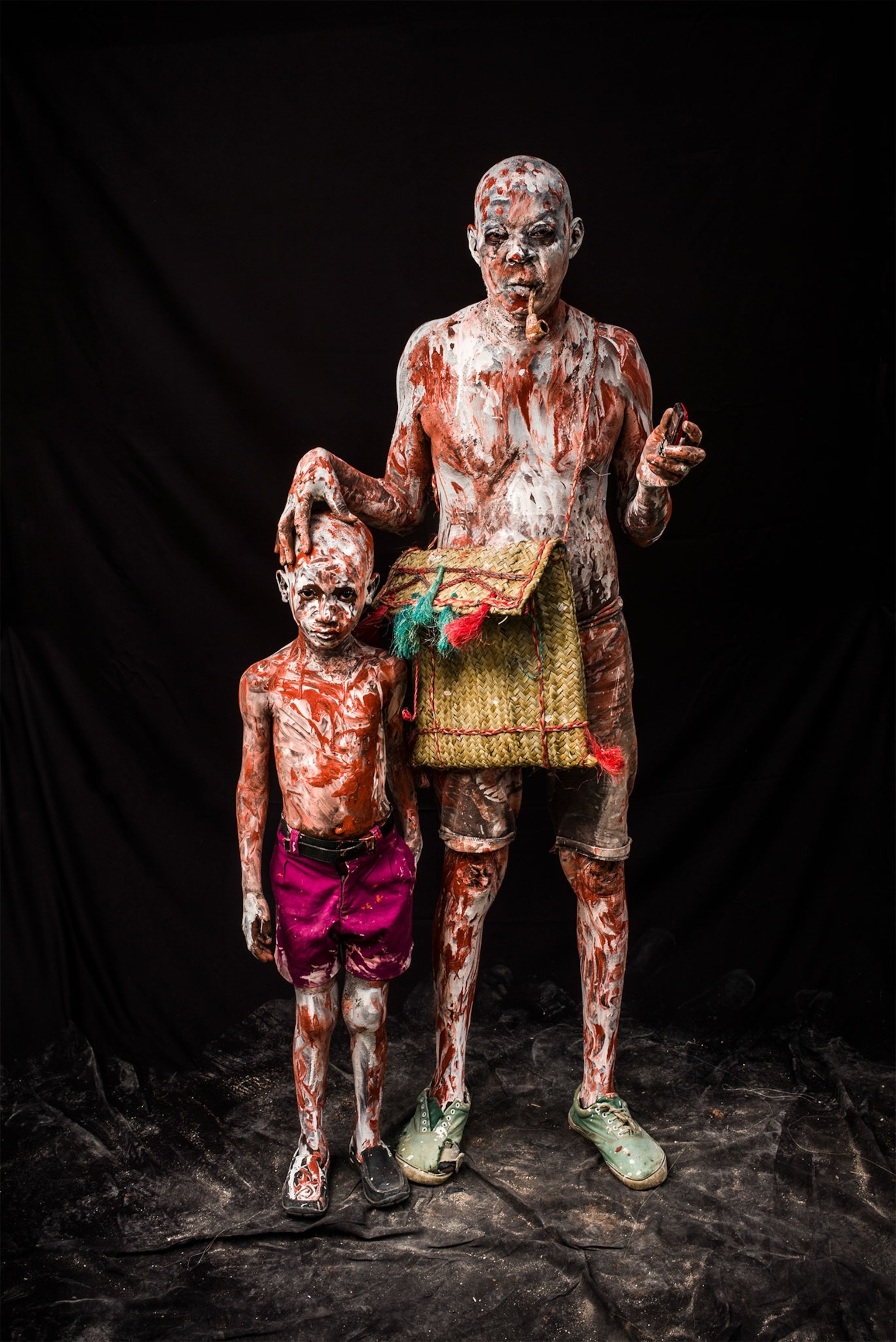 a man and boy dressed up for karnaval in Haiti