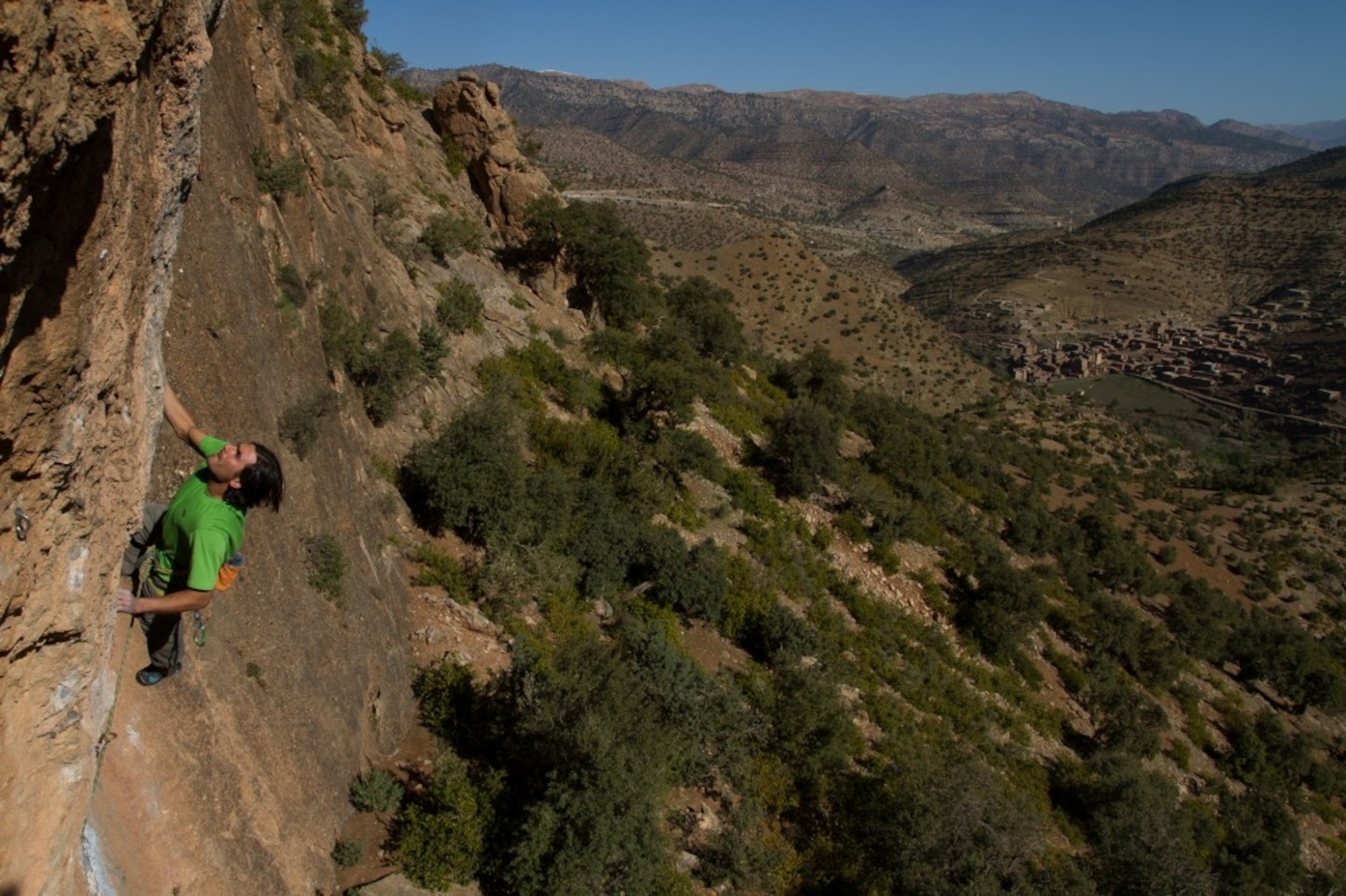 Sam Elias climbing above the village of Aguddim, photo ©Kris Erickson