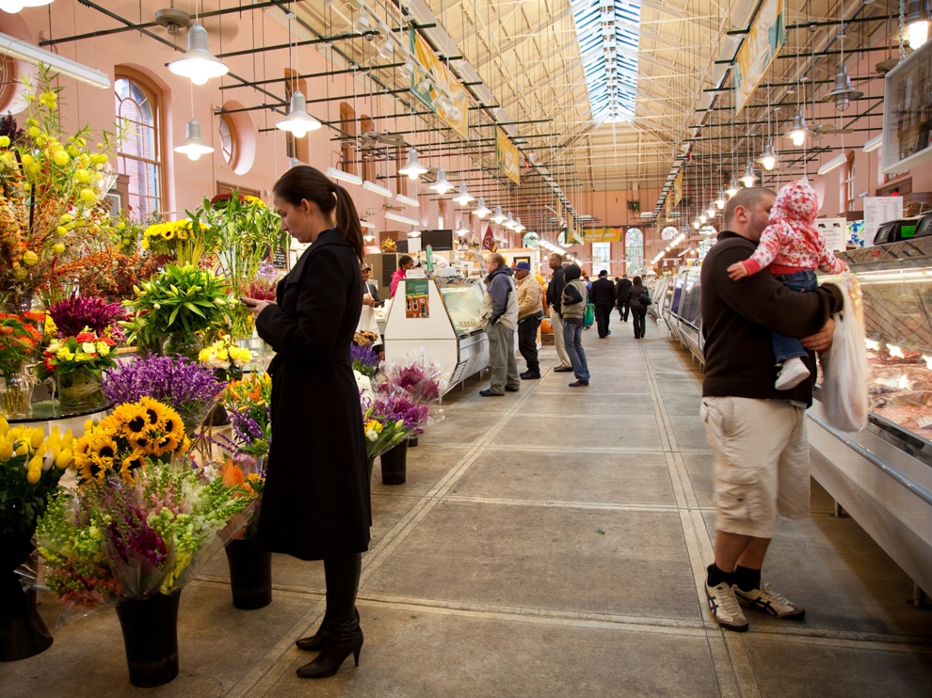 Woman buys flowers at Eastern Market, Washington D.C.