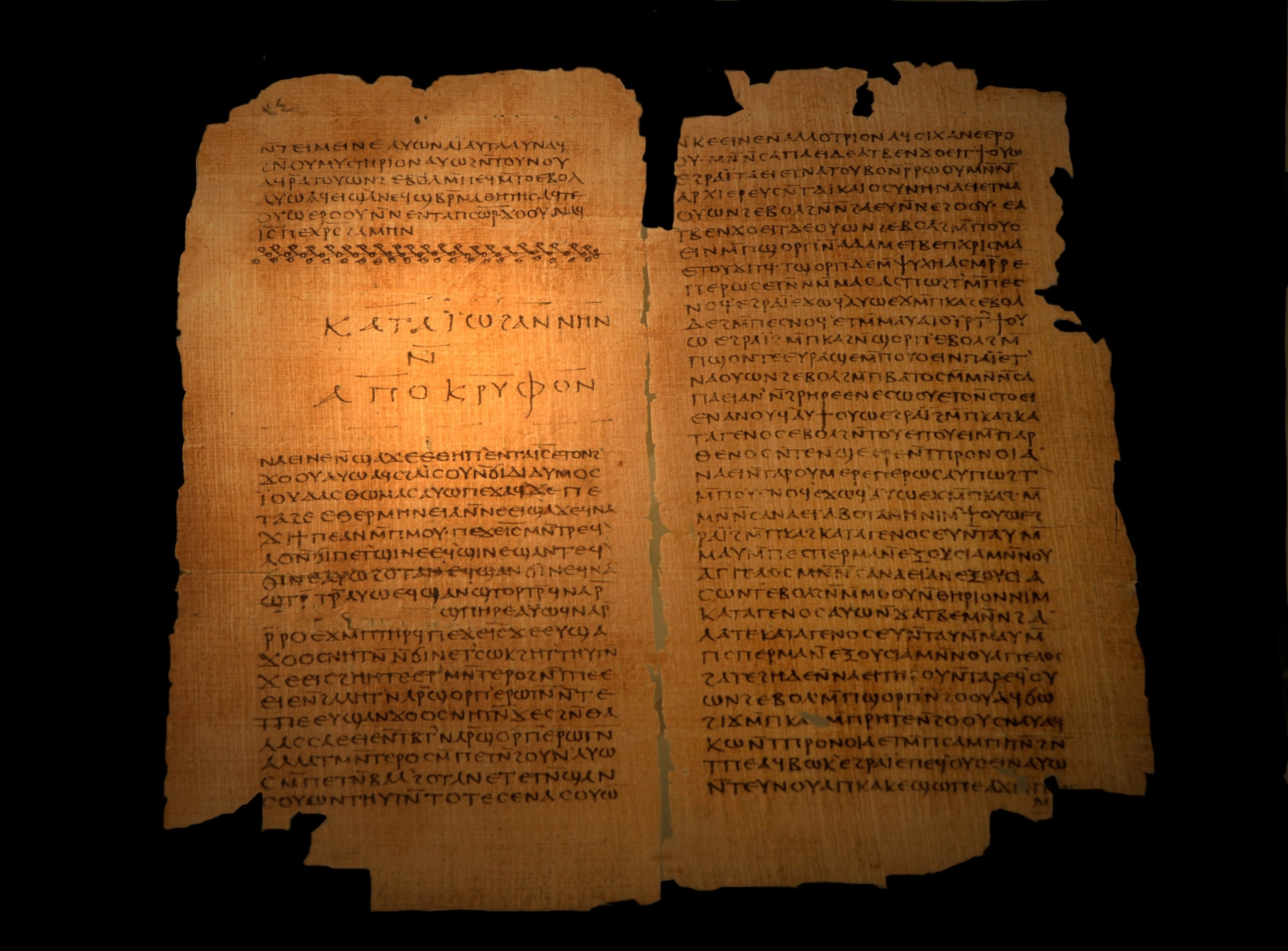 Papyrus manuscript with ancient text on two pages. The scroll has a weathered look, with dark edges