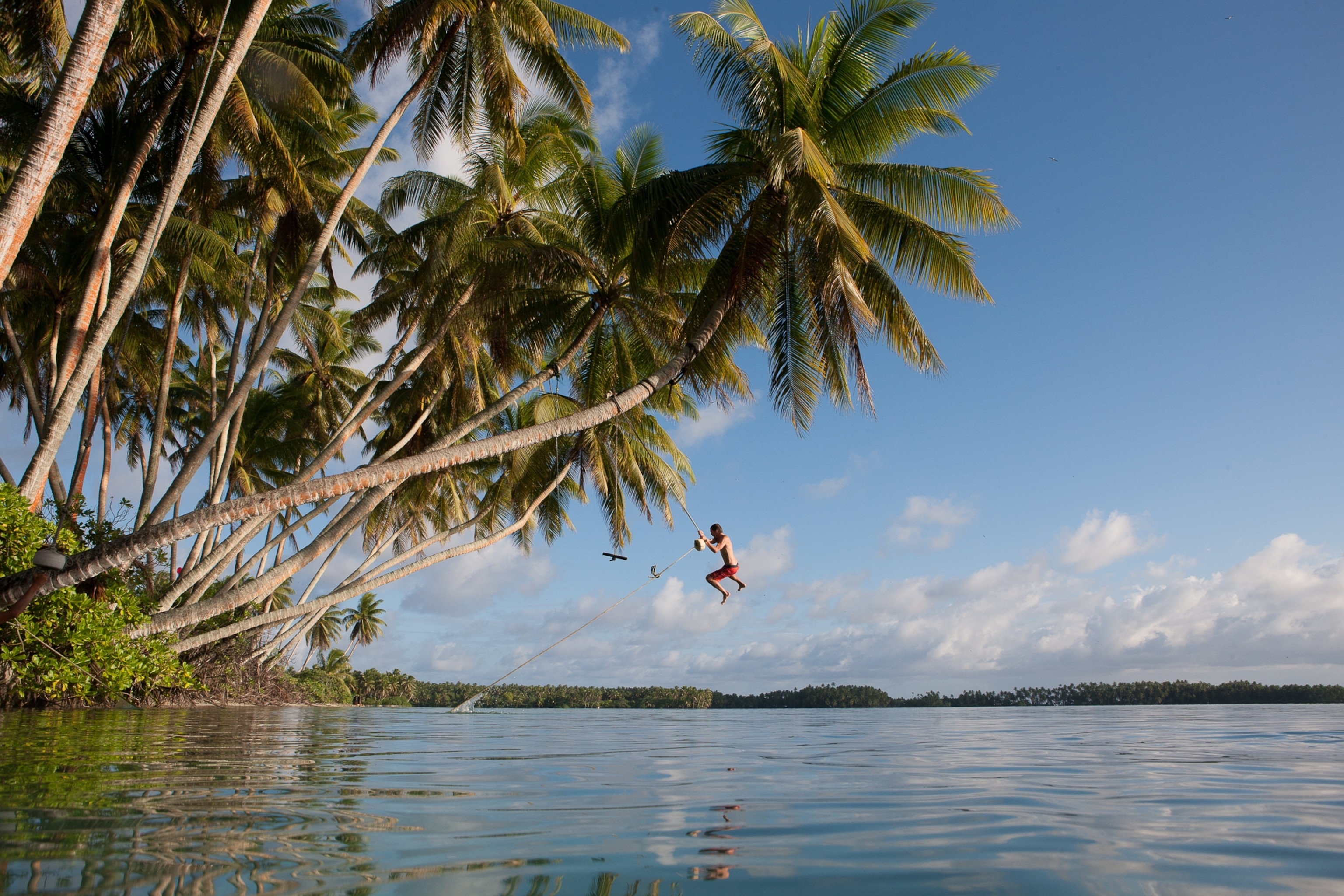 Crow White of UCSB swings out over the calm waters of the Cooper Island swimming hole. Palmyra Atoll.